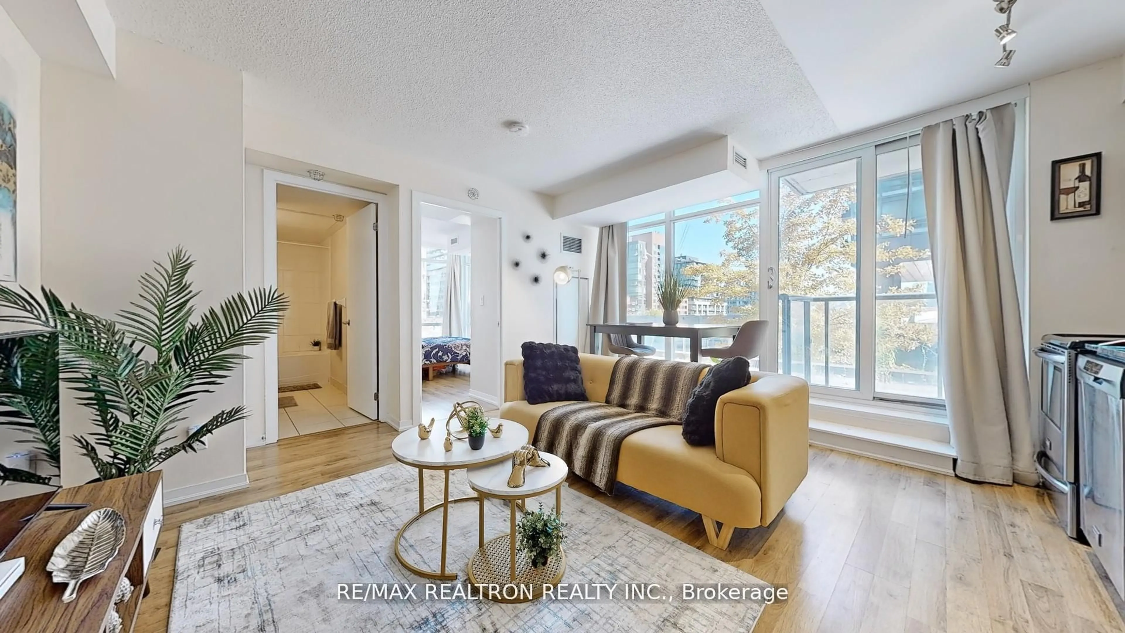 Living room with furniture, unknown for 20 Joe Shuster Way ##202, Toronto Ontario M6K 0A3