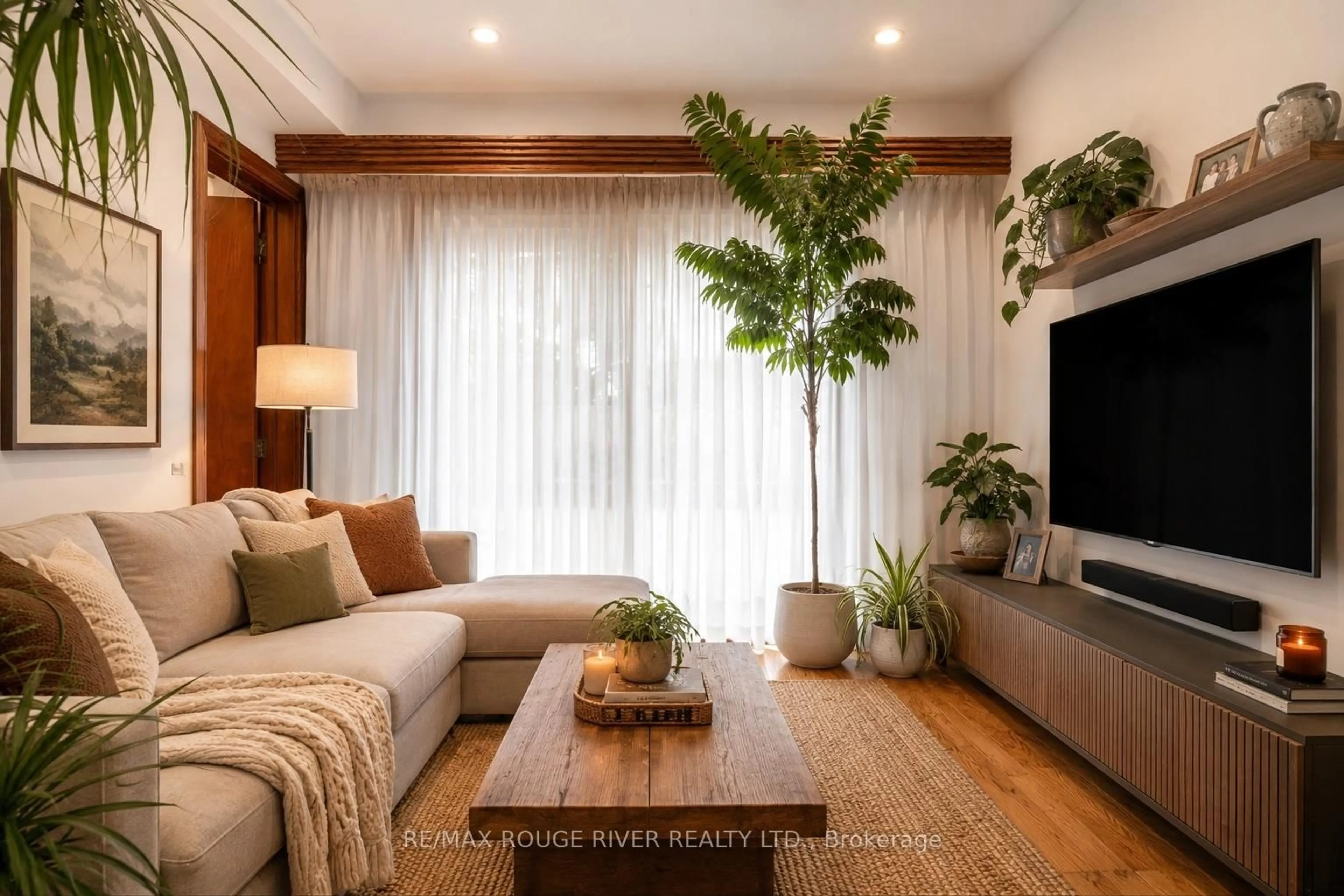 Living room with furniture, wood/laminate floor for 2 Faversham Cres, Toronto Ontario M9C 3X4