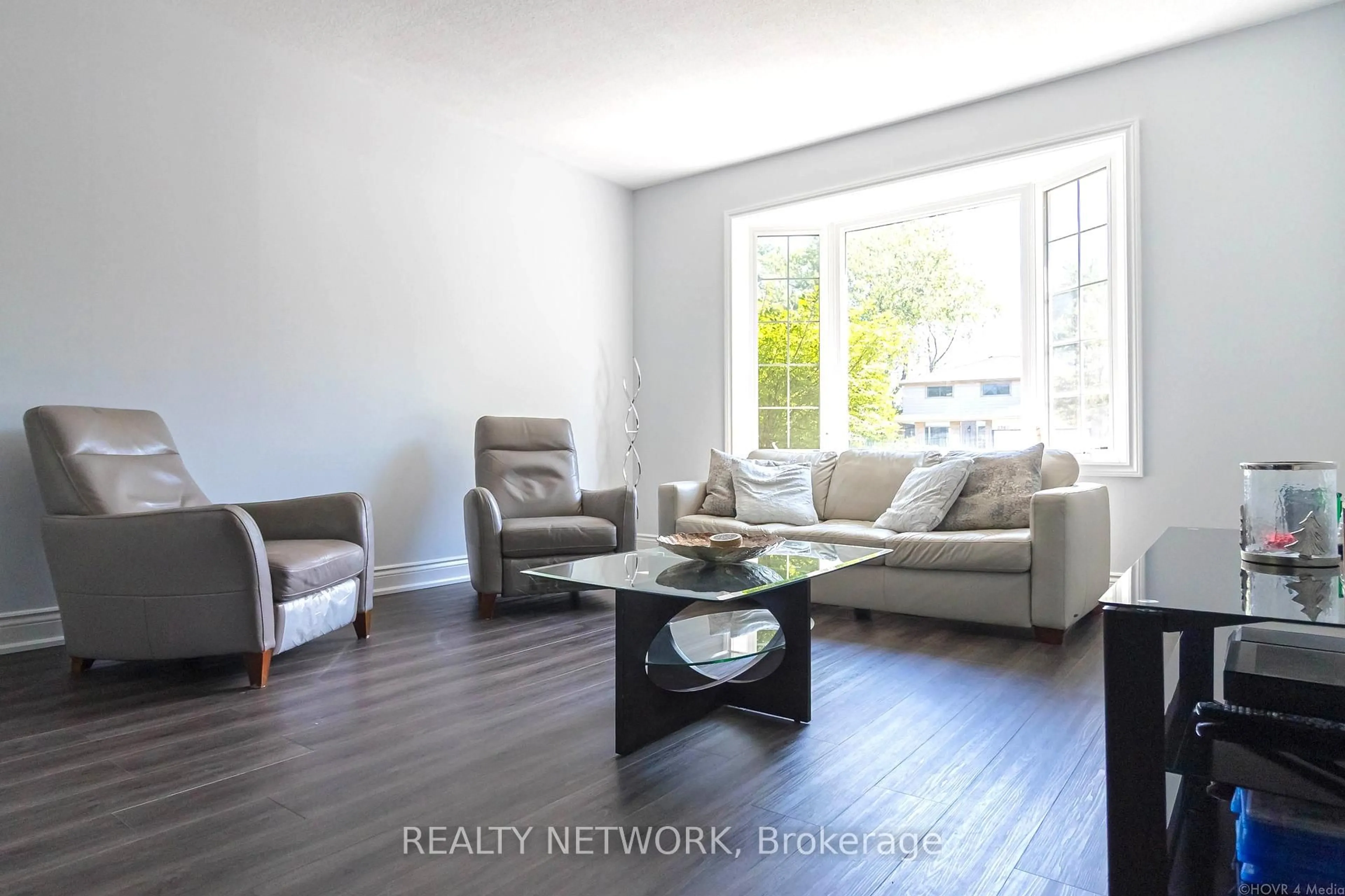 Living room with furniture, wood/laminate floor for 2390 Sinclair Circ, Burlington Ontario L7P 3C3