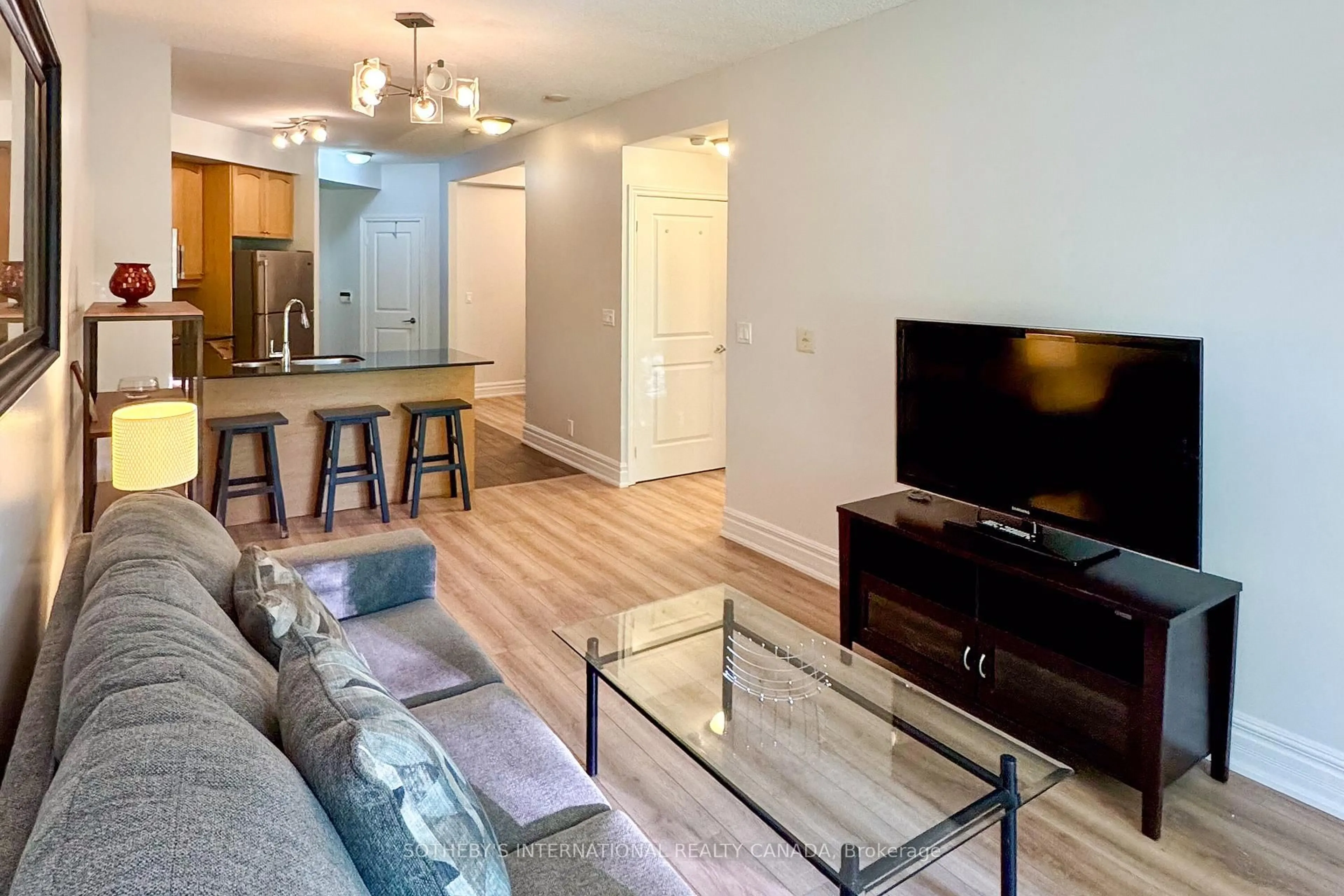 Living room with furniture, wood/laminate floor for 70 Absolute Ave #306, Mississauga Ontario L4Z 0A4