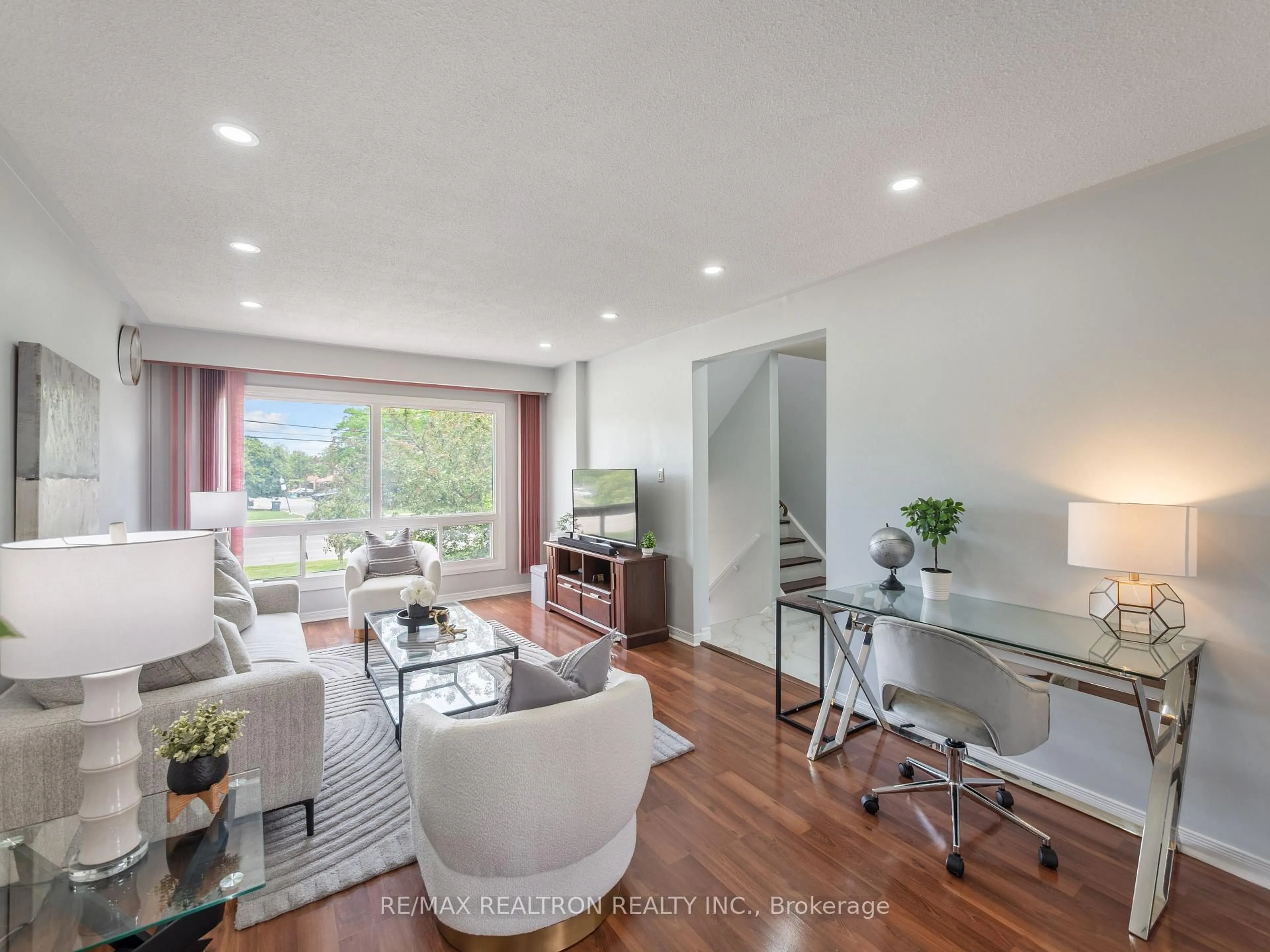 Living room with furniture, wood/laminate floor for 7500 Goreway Dr #37, Mississauga Ontario L4T 3C7