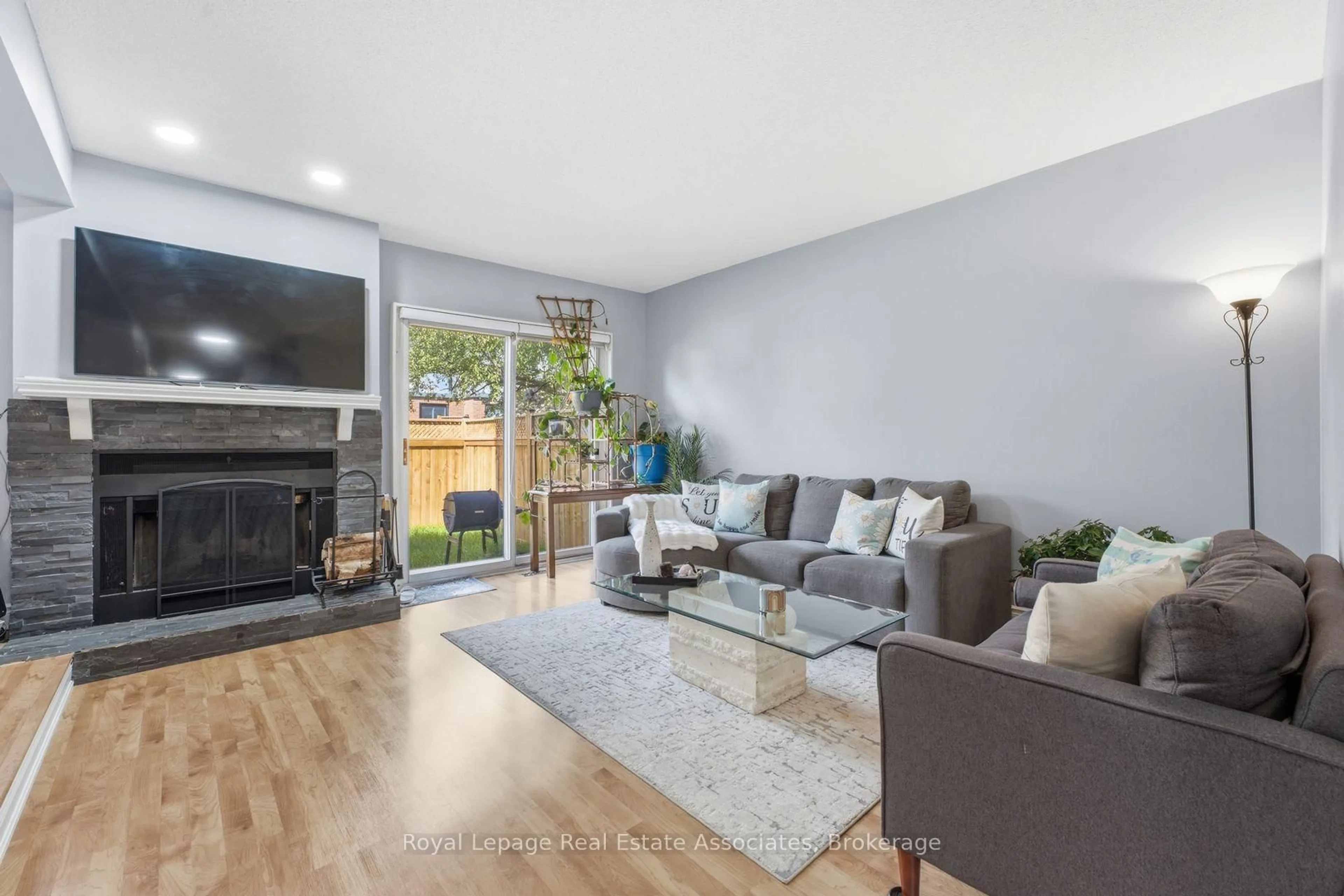 Living room with furniture, wood/laminate floor for 3050 Orleans Rd #111, Mississauga Ontario L5L 5P7