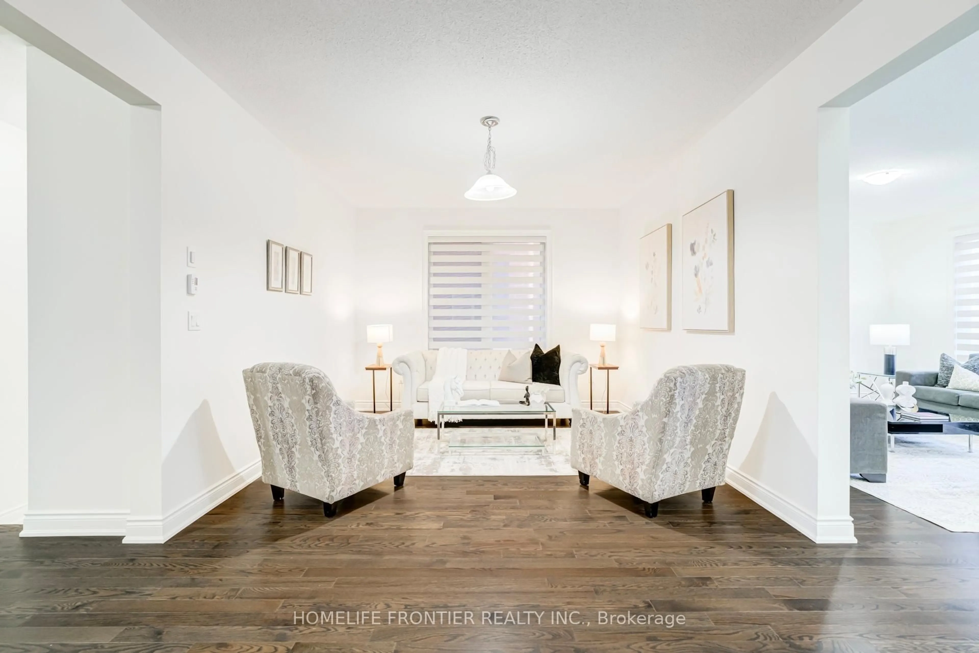 Living room with furniture, wood/laminate floor for 16 Gladmary Dr, Brampton Ontario L6Y 6K9