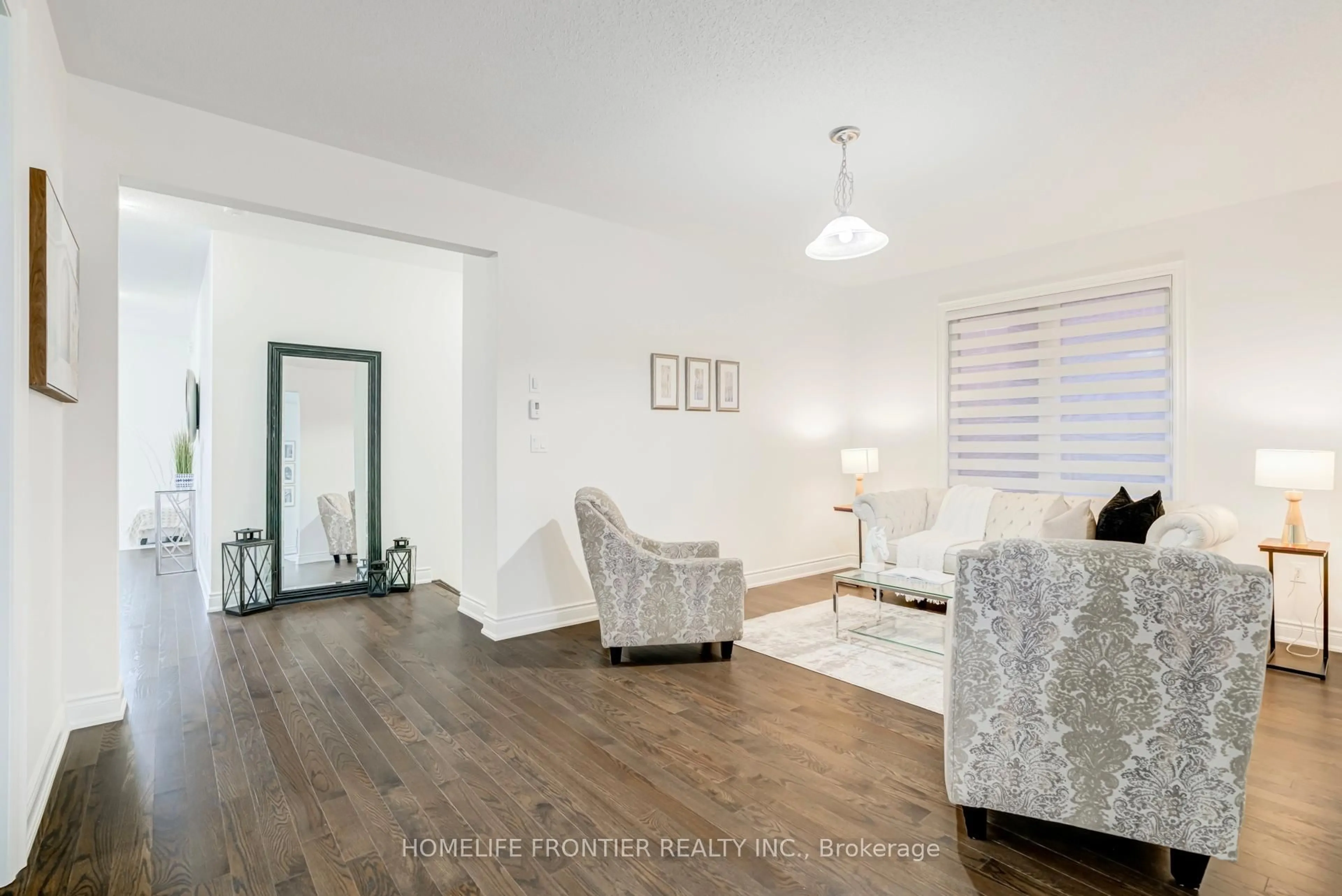 Living room with furniture, wood/laminate floor for 16 Gladmary Dr, Brampton Ontario L6Y 6K9