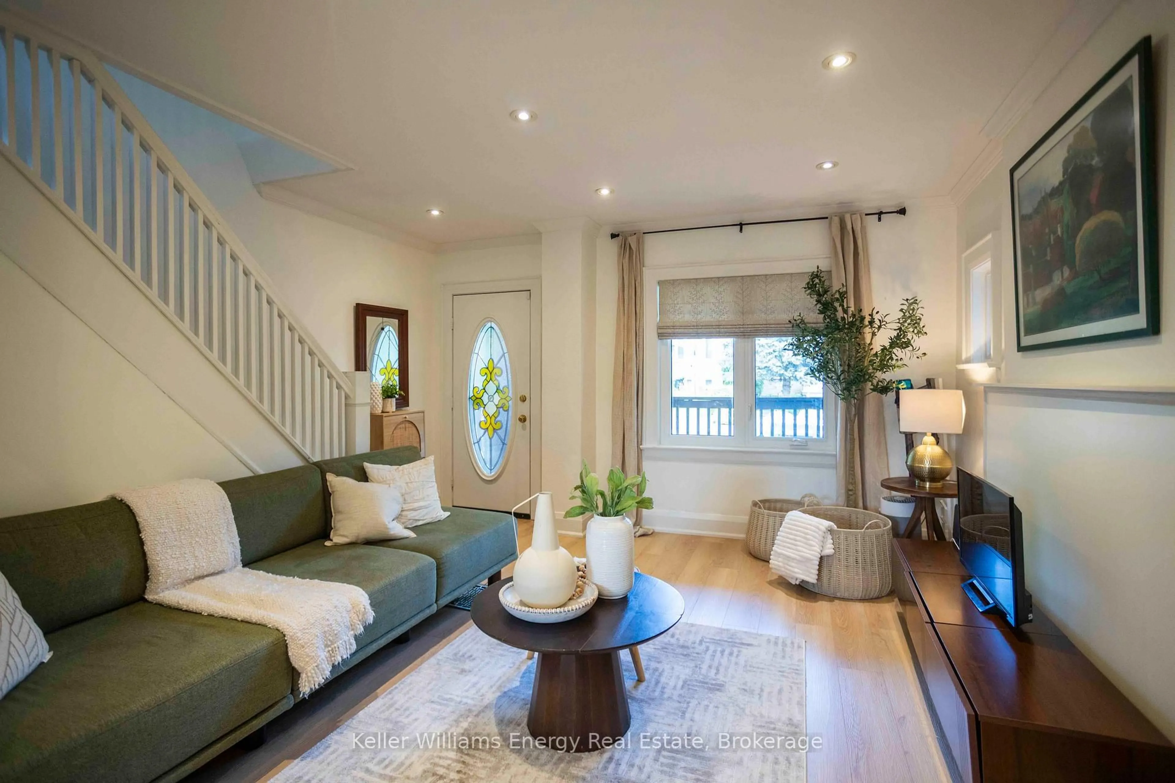 Living room with furniture, wood/laminate floor for 134 Mcroberts Ave, Toronto Ontario M6E 4P5
