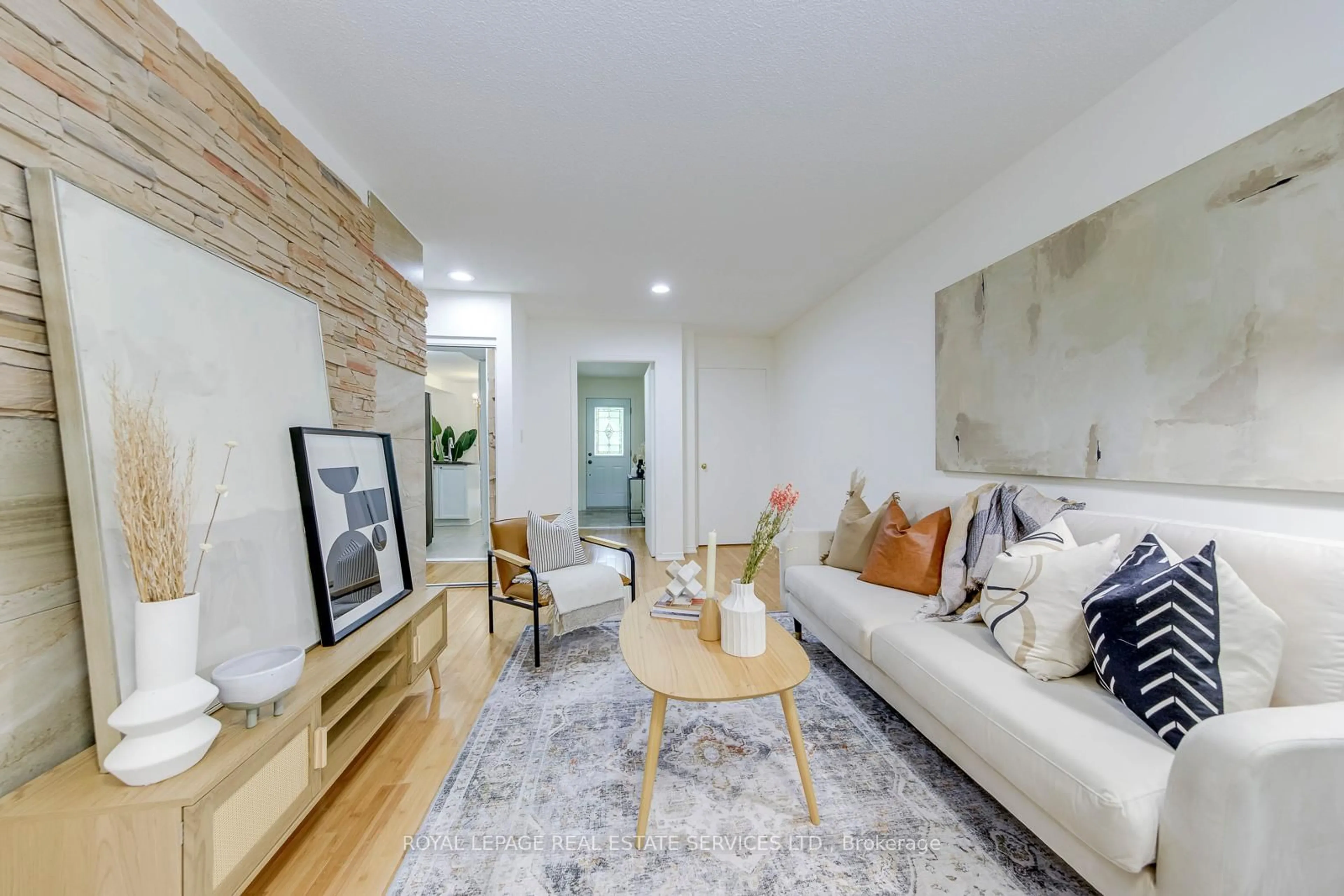 Living room with furniture, wood/laminate floor for 6950 Tenth Line #78, Mississauga Ontario L5N 6Y1