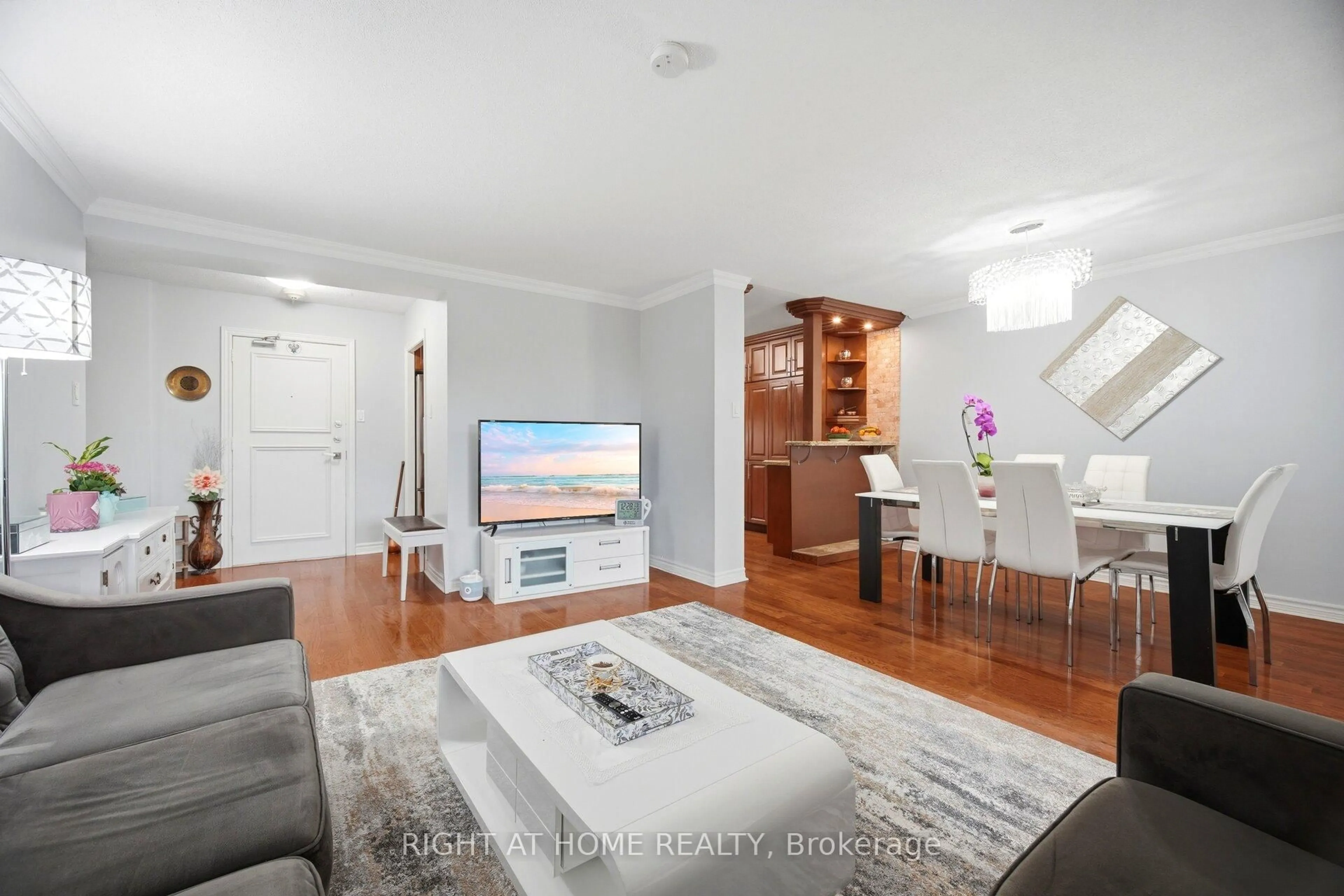Living room with furniture, wood/laminate floor for 627 The West Mall #306, Toronto Ontario M9C 4X5