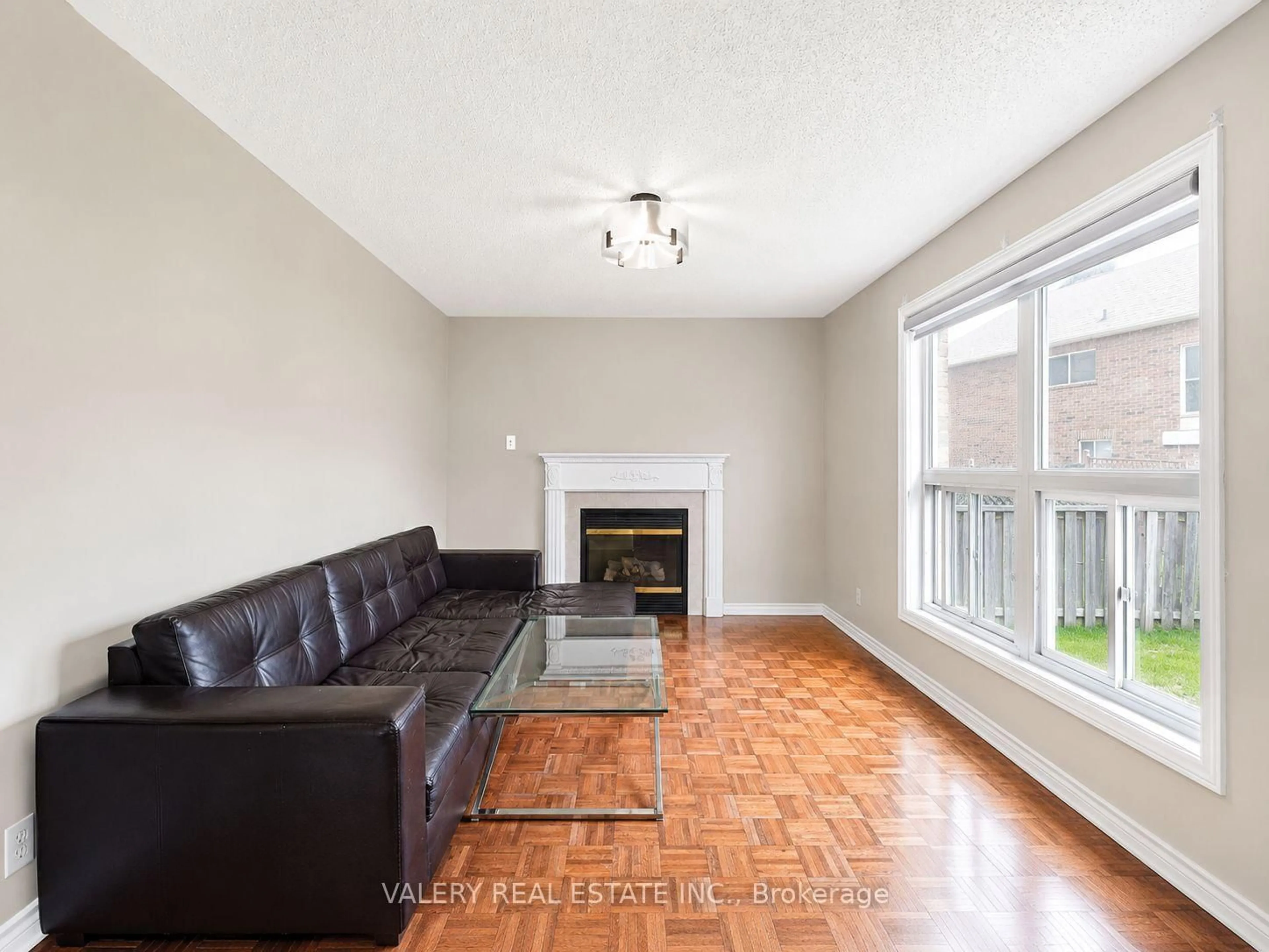 Living room with furniture, wood/laminate floor for 15 Silktop Tr, Brampton Ontario L6R 2K4