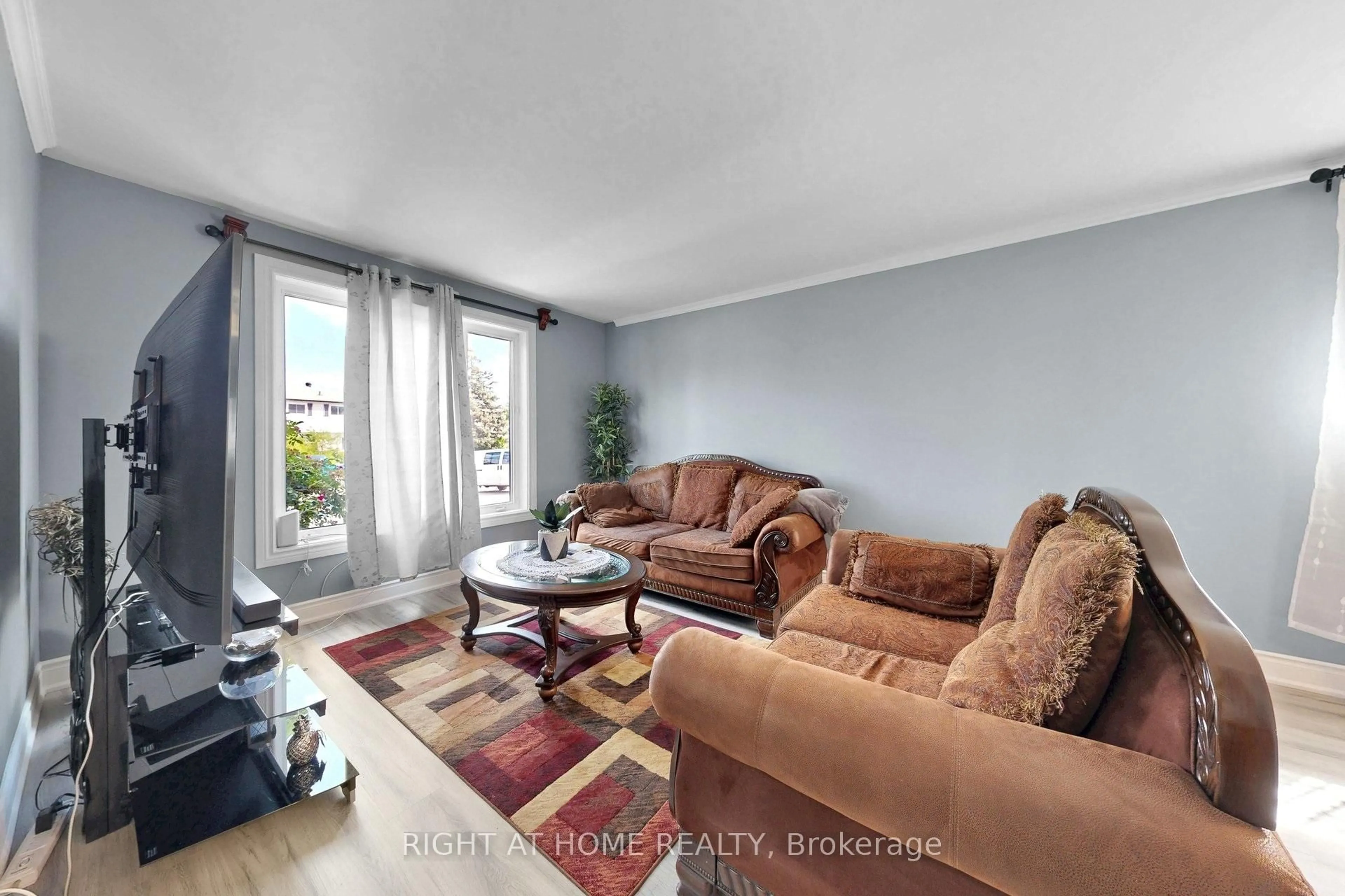 Living room with furniture, wood/laminate floor for 41 Flamingo Cres, Brampton Ontario L6T 2G6