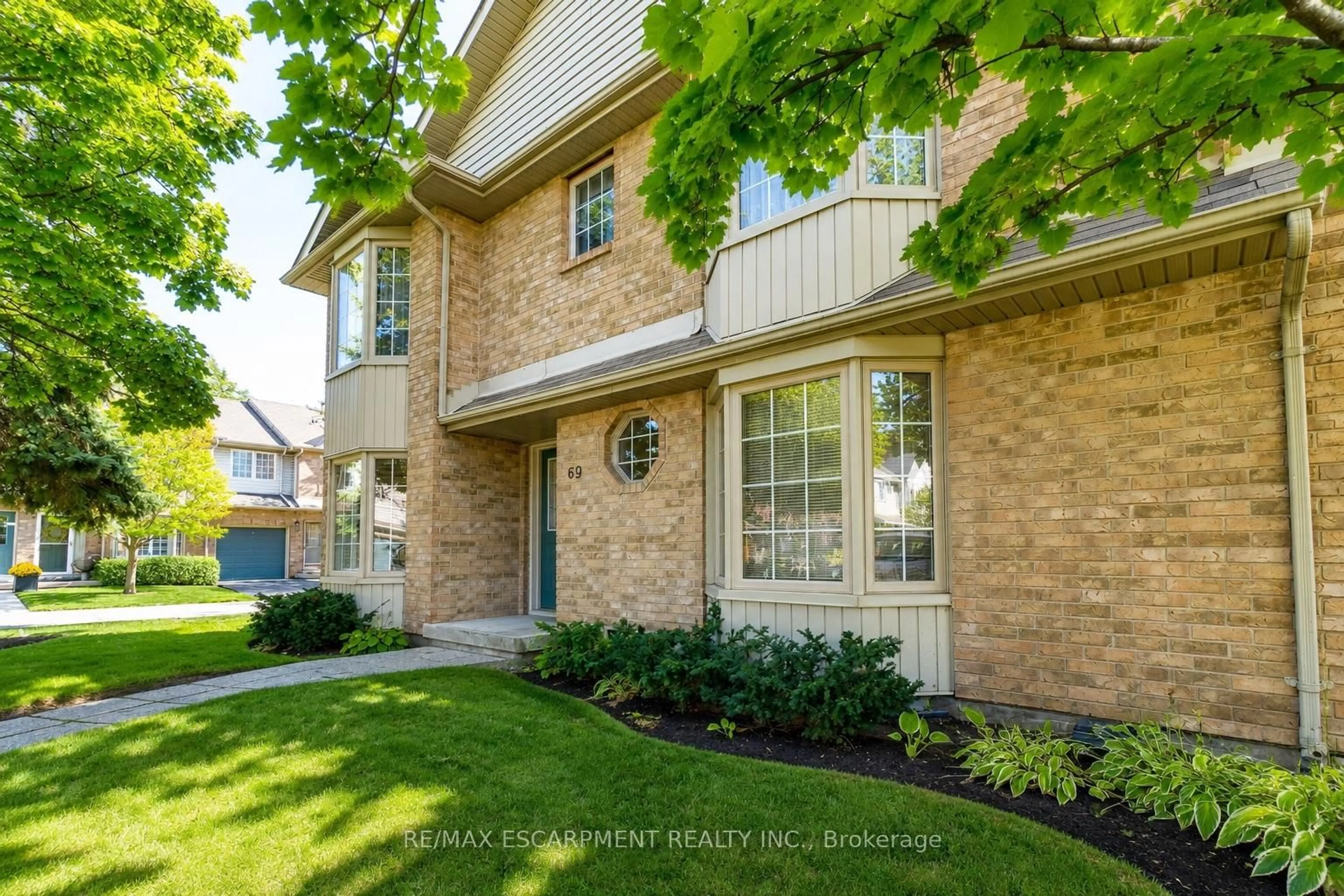 Home with brick exterior material, street for 3333 New St #69, Burlington Ontario L7N 1N1