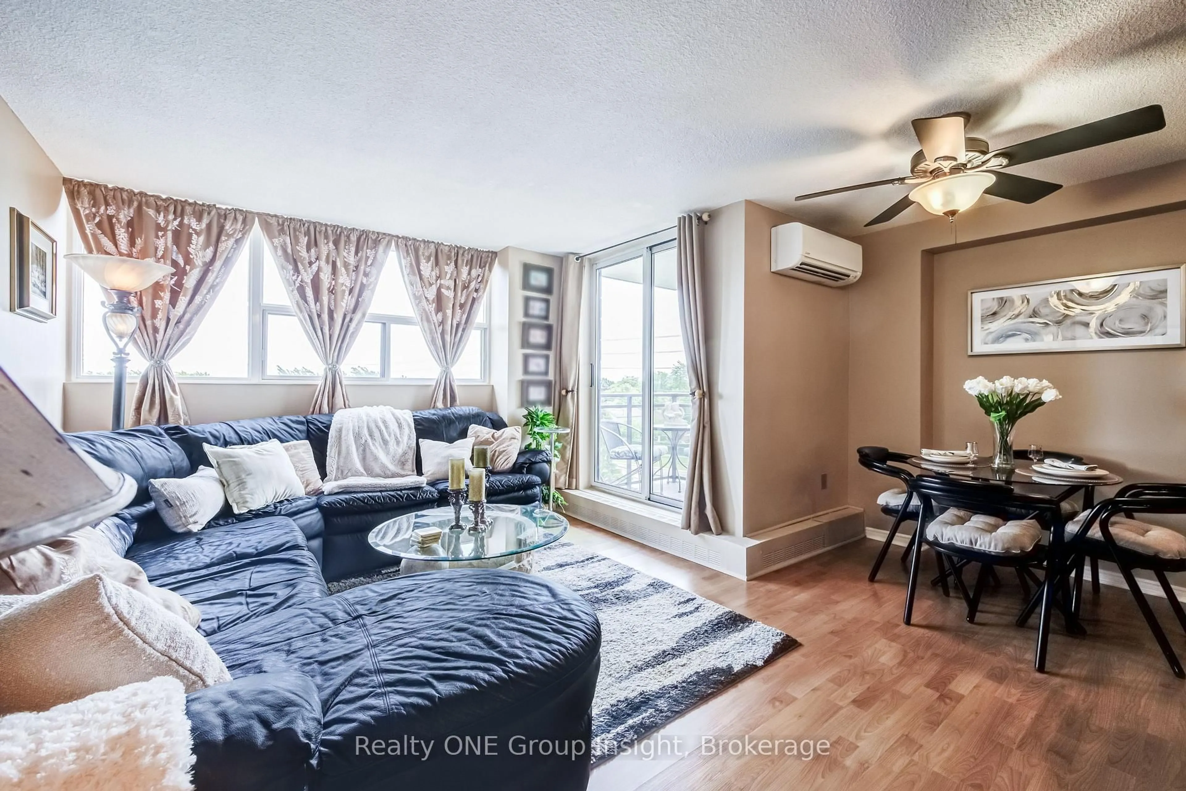 Living room with furniture, wood/laminate floor for 2900 Battleford Rd #516, Mississauga Ontario L5N 2V9