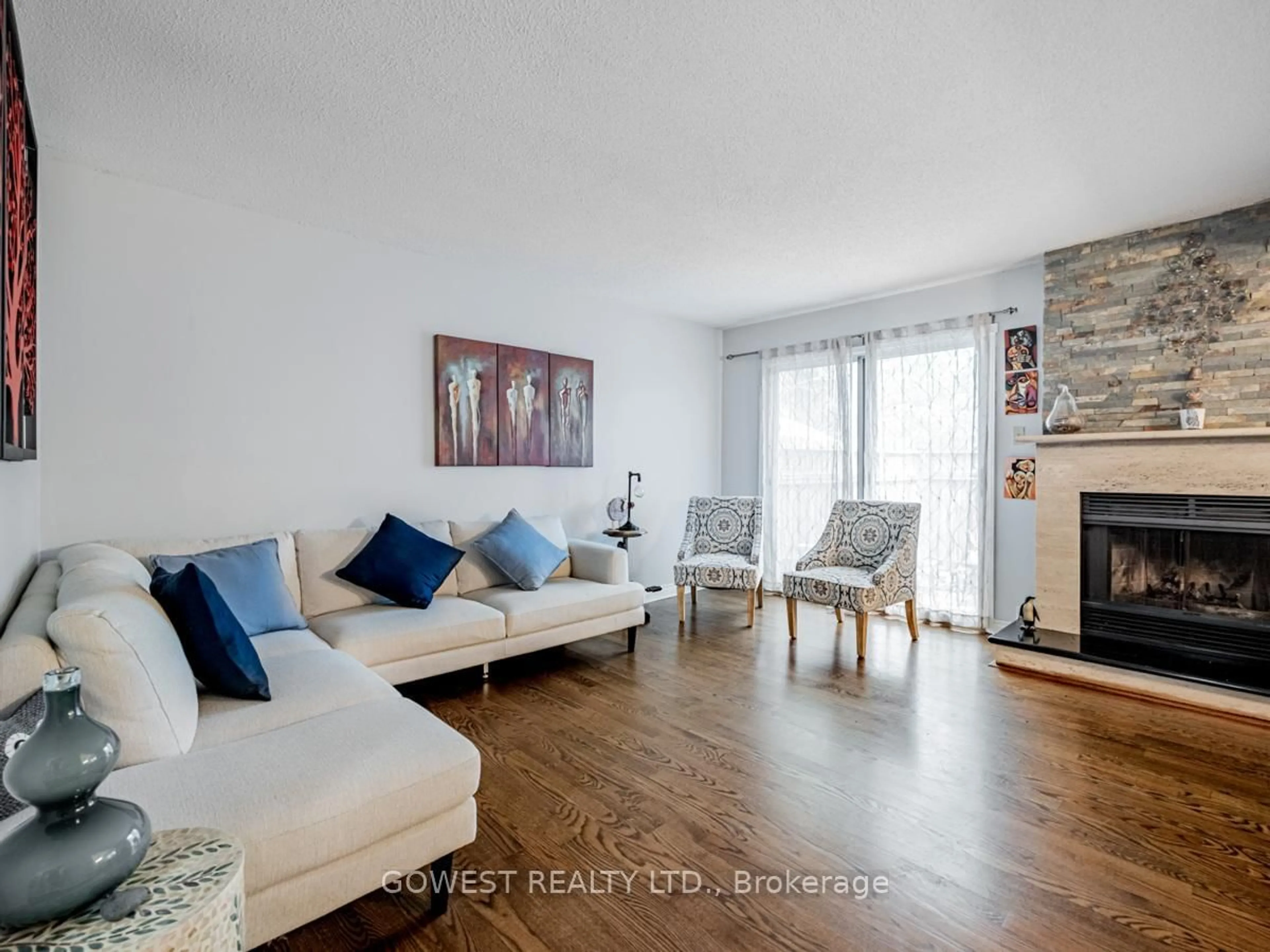 Living room with furniture, wood/laminate floor for 3050 Orleans Rd #31, Mississauga Ontario L5L 5P7
