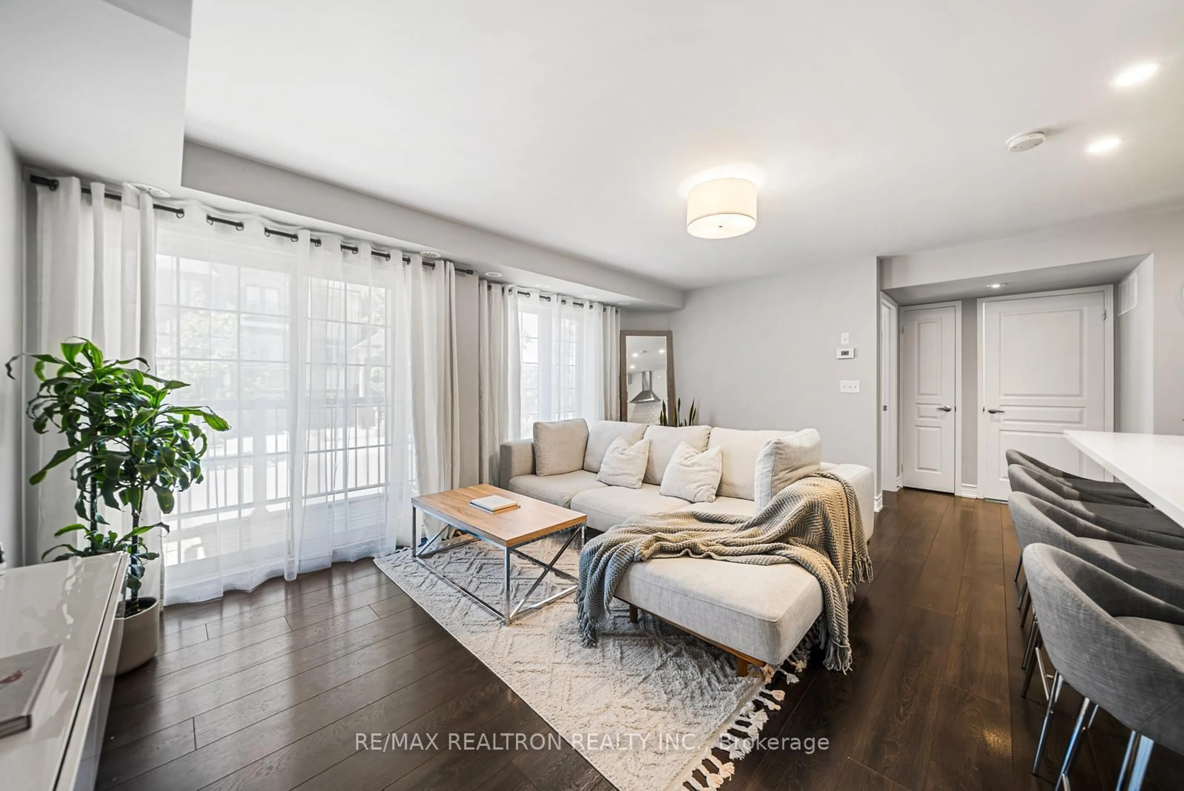Living room with furniture, wood/laminate floor for 161 Isaac Devins Blvd #5, Toronto Ontario M9M 0C5