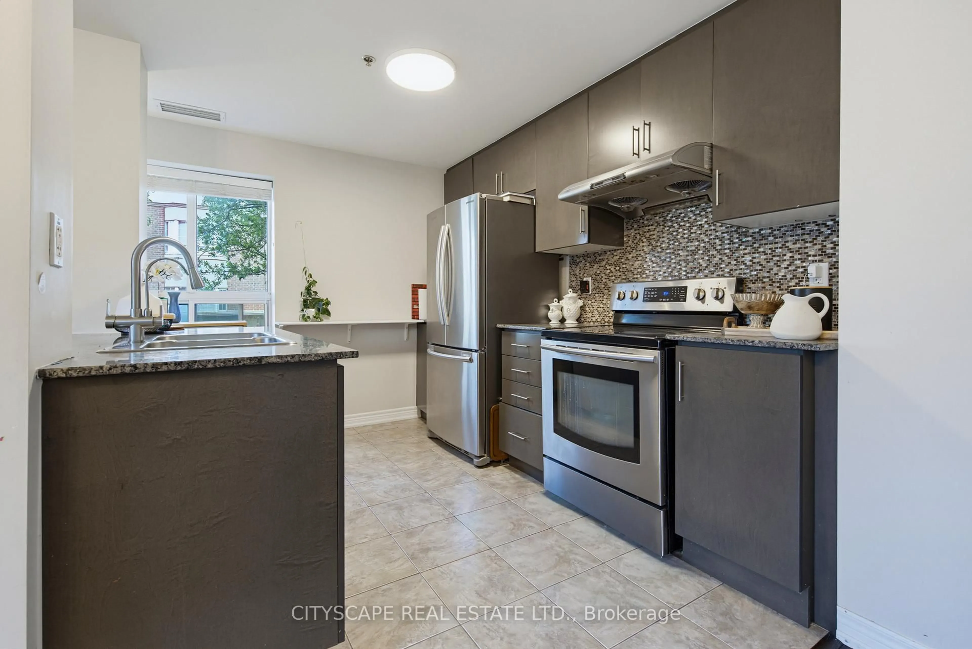 Open concept kitchen, ceramic/tile floor for 1419 Costigan Rd #103, Milton Ontario L9T 2L4
