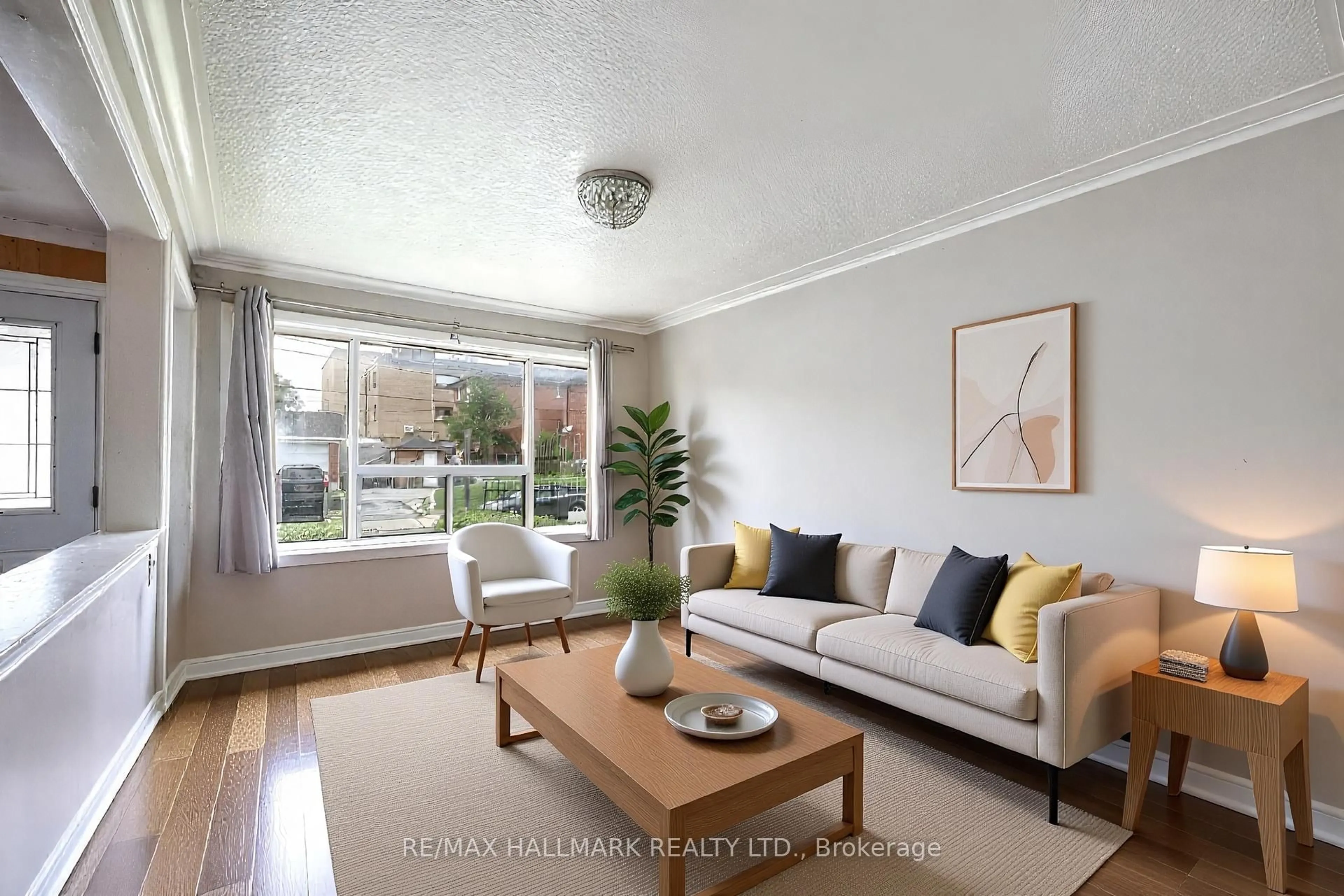 Living room with furniture, wood/laminate floor for 139 Kitchener Ave, Toronto Ontario M6E 2B9