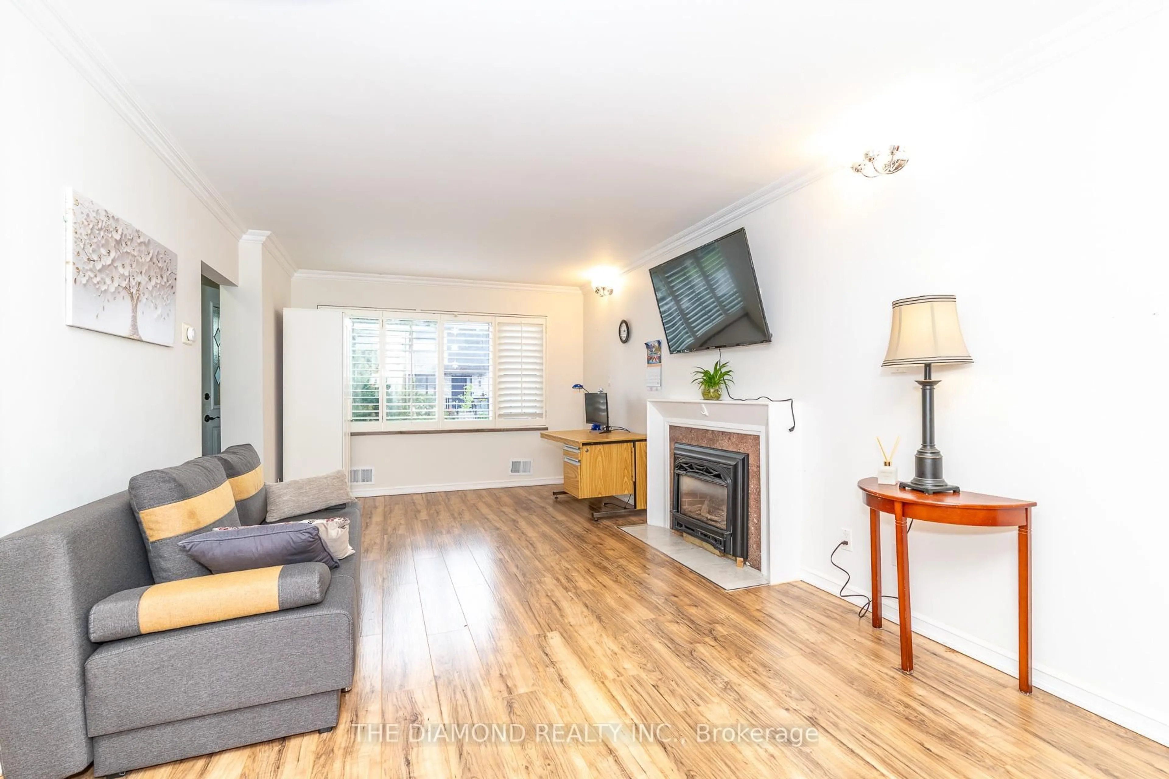 Living room with furniture, wood/laminate floor for 75 Glen Agar Dr, Toronto Ontario M9B 5M2
