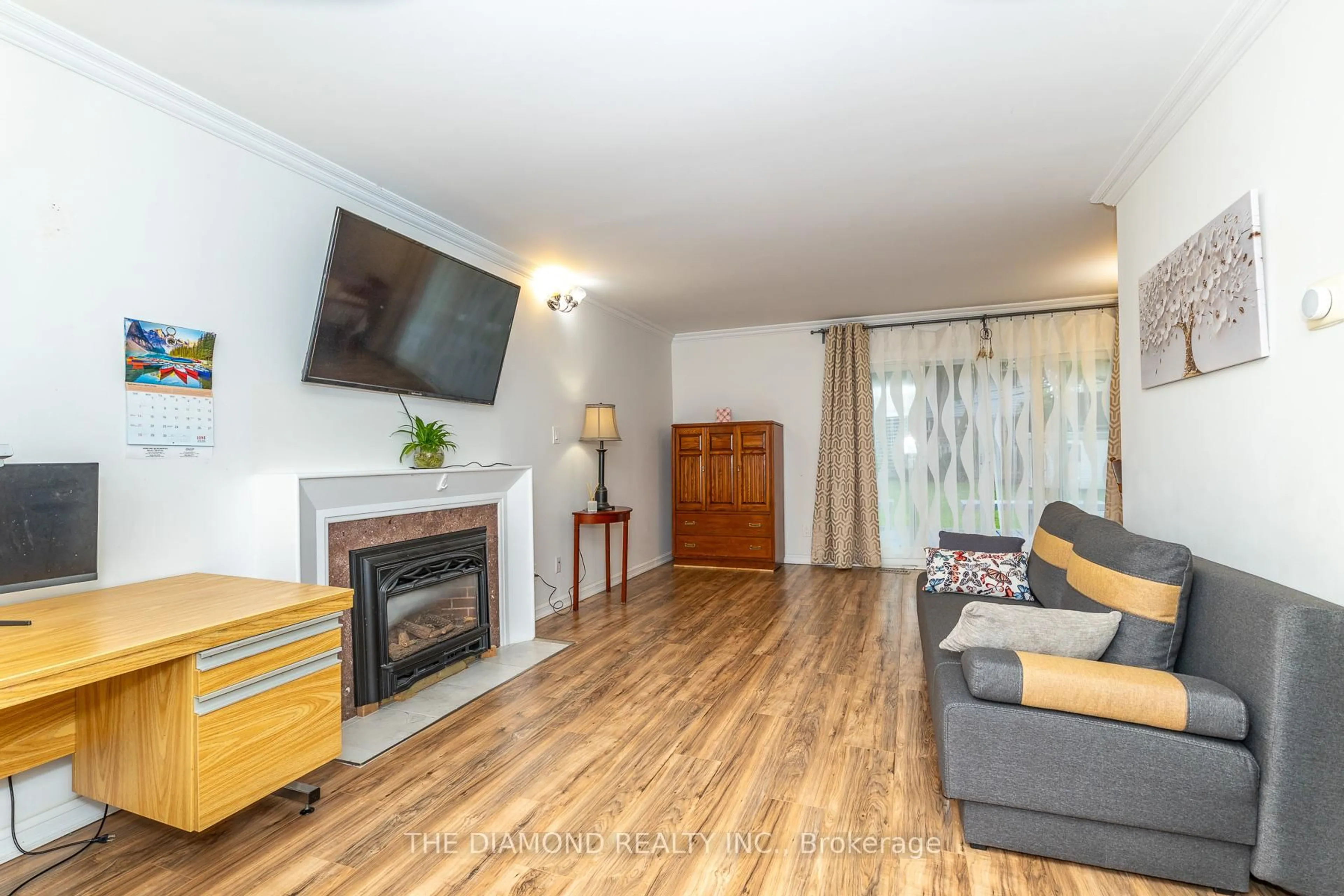 Living room with furniture, wood/laminate floor for 75 Glen Agar Dr, Toronto Ontario M9B 5M2