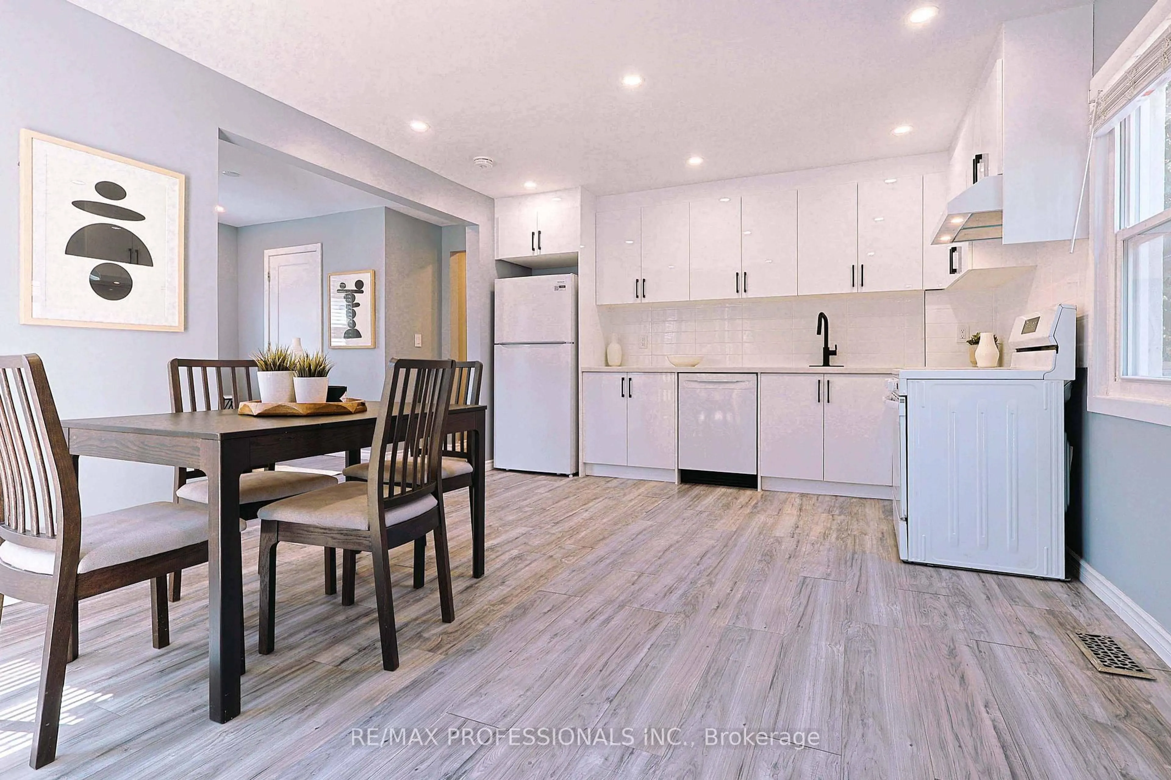 Open concept kitchen, wood/laminate floor for 76 Macdonald St, Toronto Ontario M8V 1Y4