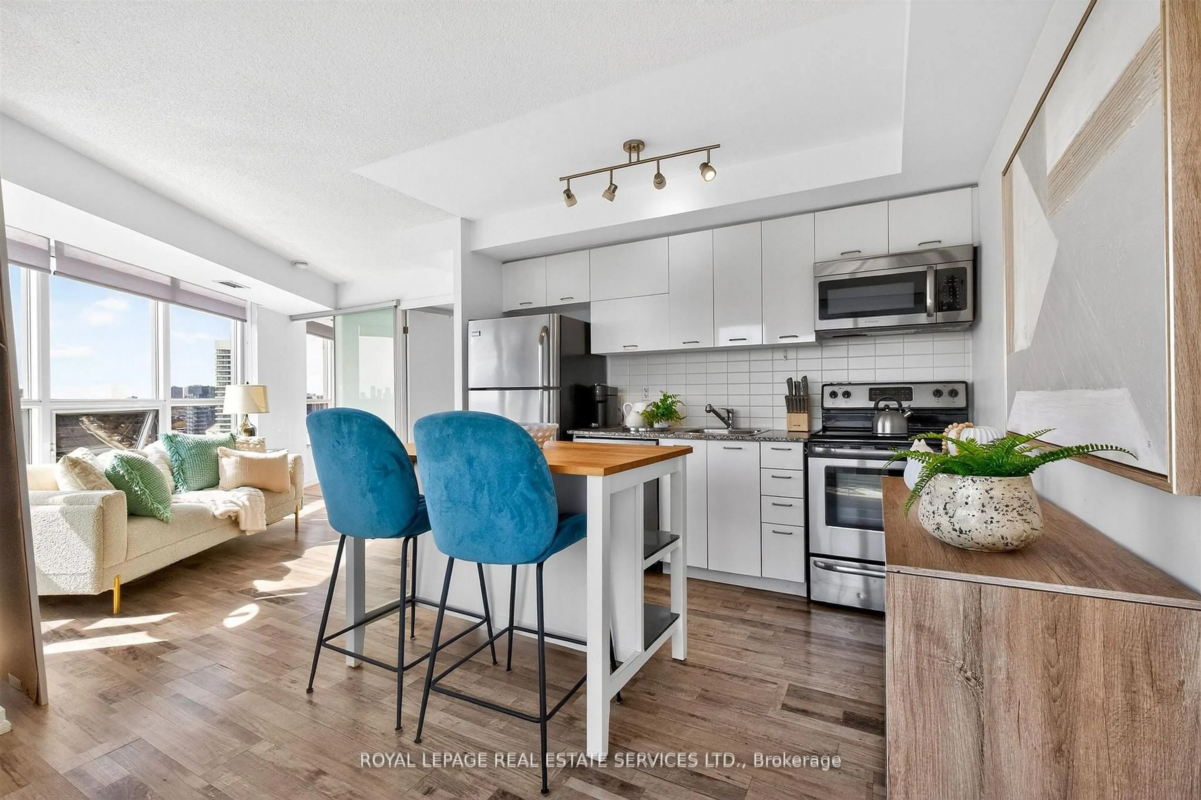 Open concept kitchen, wood/laminate floor for 38 Joe Shuster Way #1318, Toronto Ontario M6K 0A5
