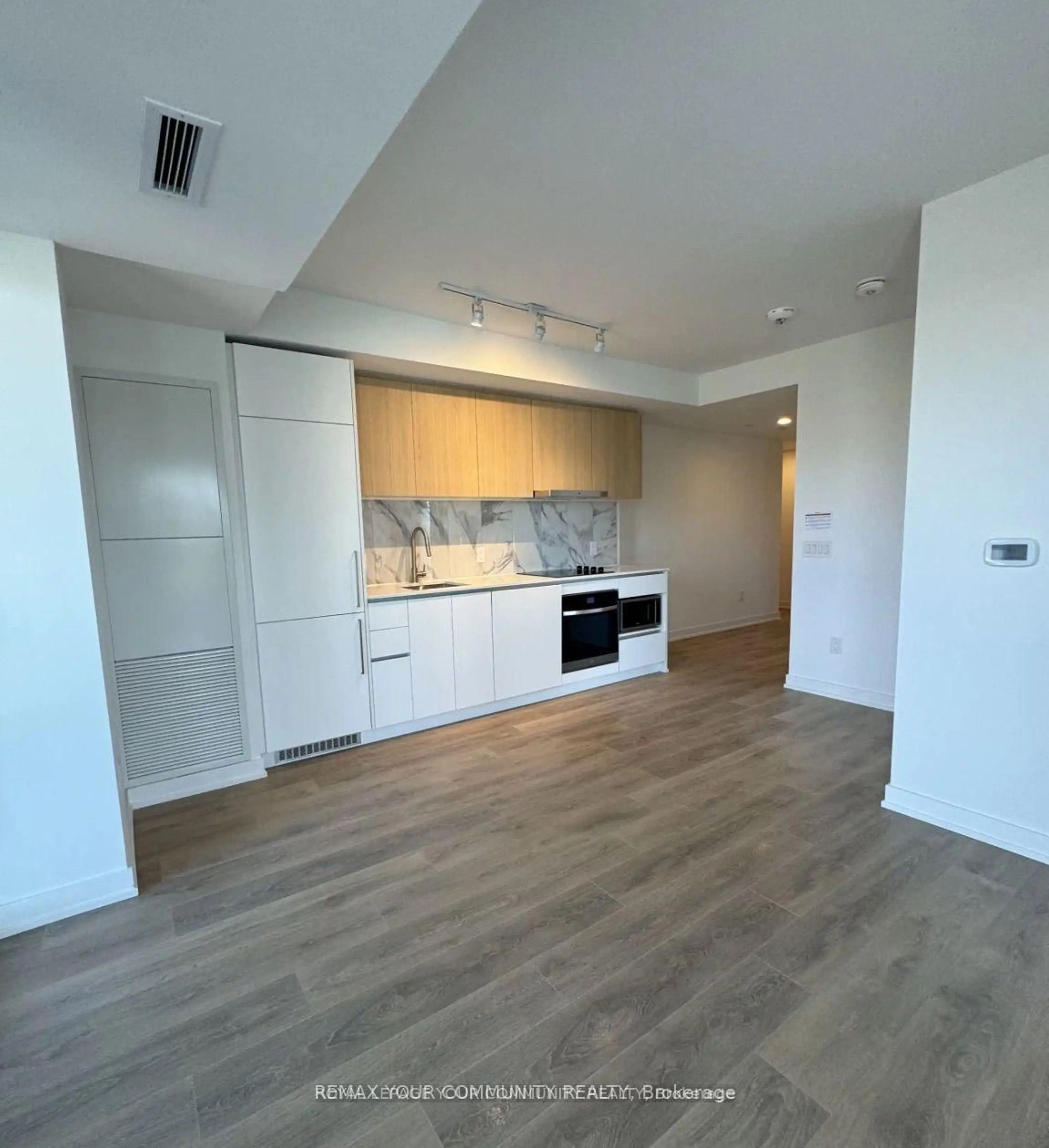 Open concept kitchen, wood/laminate floor for 1100 Sheppard Ave #225, Toronto Ontario M3K 0E4