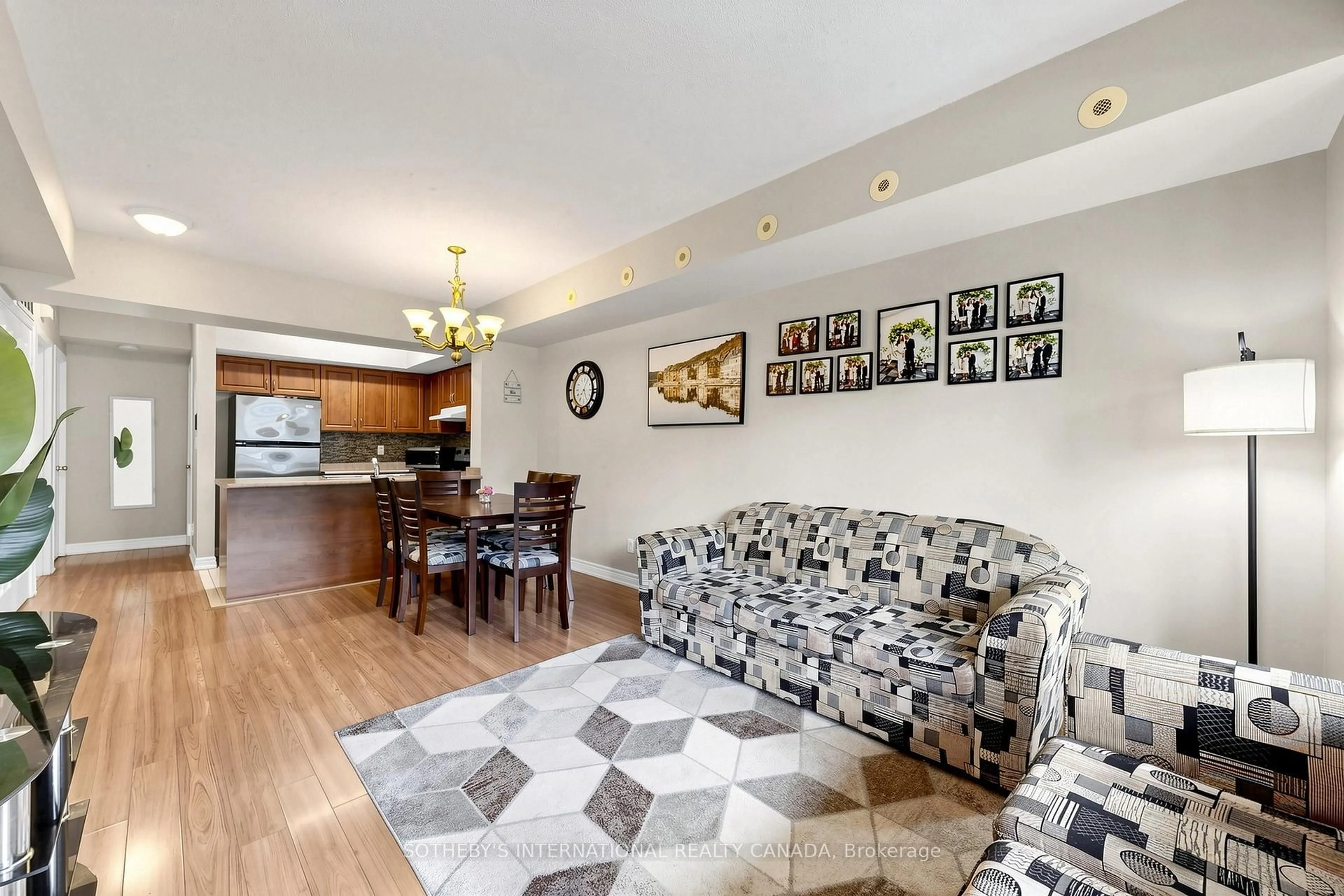 Living room with furniture, wood/laminate floor for 3035 Finch Ave #2012, Toronto Ontario M9M 0A2