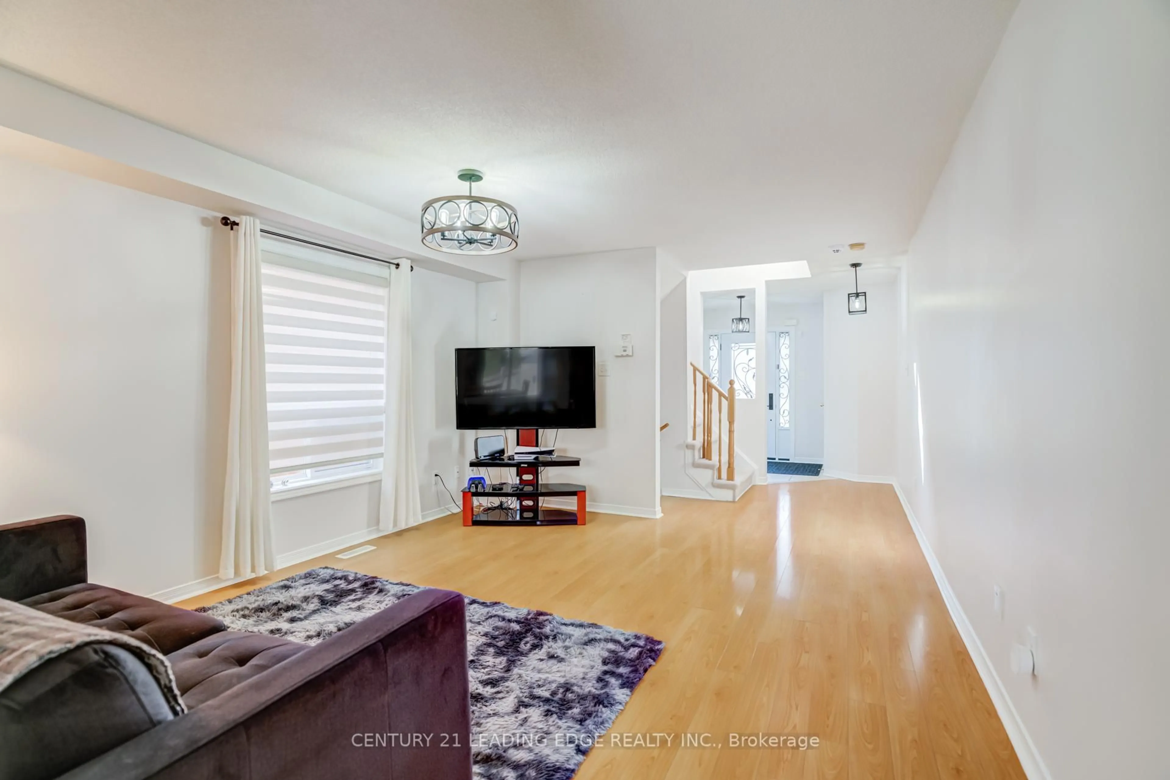 Living room with furniture, wood/laminate floor for 13 Grape Tr, Brampton Ontario L7A 2V7