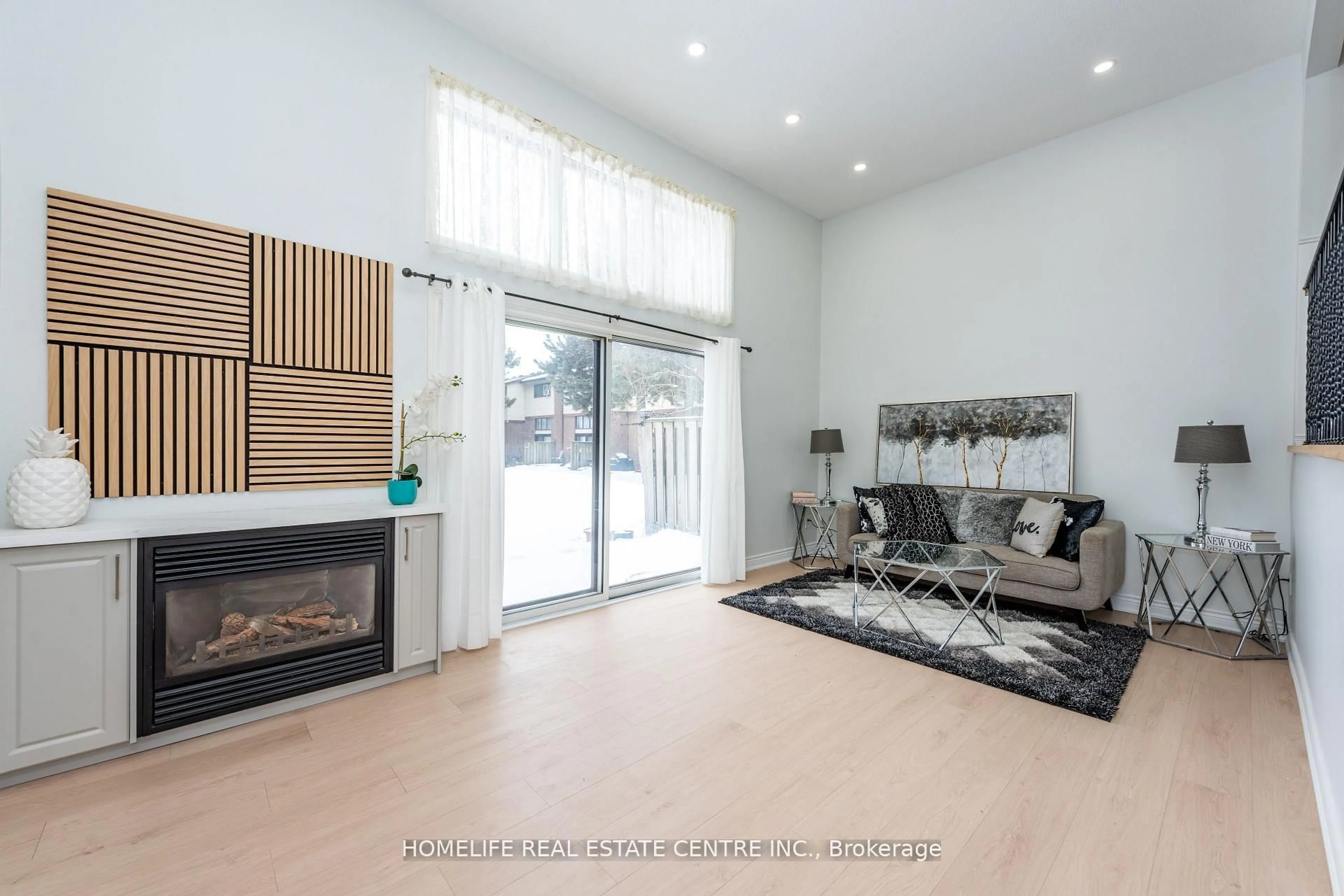 Living room with furniture, wood/laminate floor for 62 Mccallum Crt, Brampton Ontario L6W 3M4