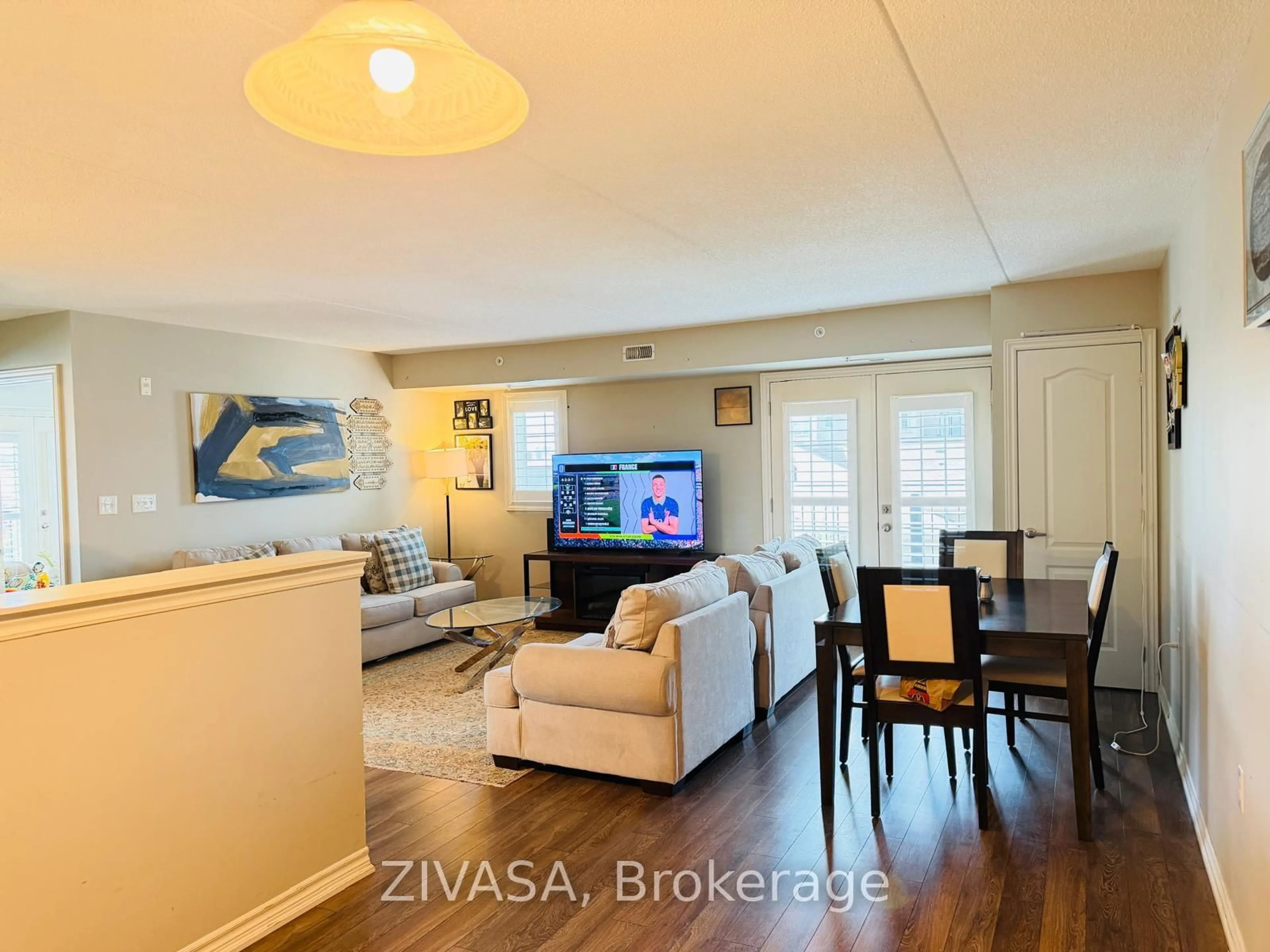 Living room with furniture, wood/laminate floor for 1470 MAIN St #316, Milton Ontario L9T 8W6