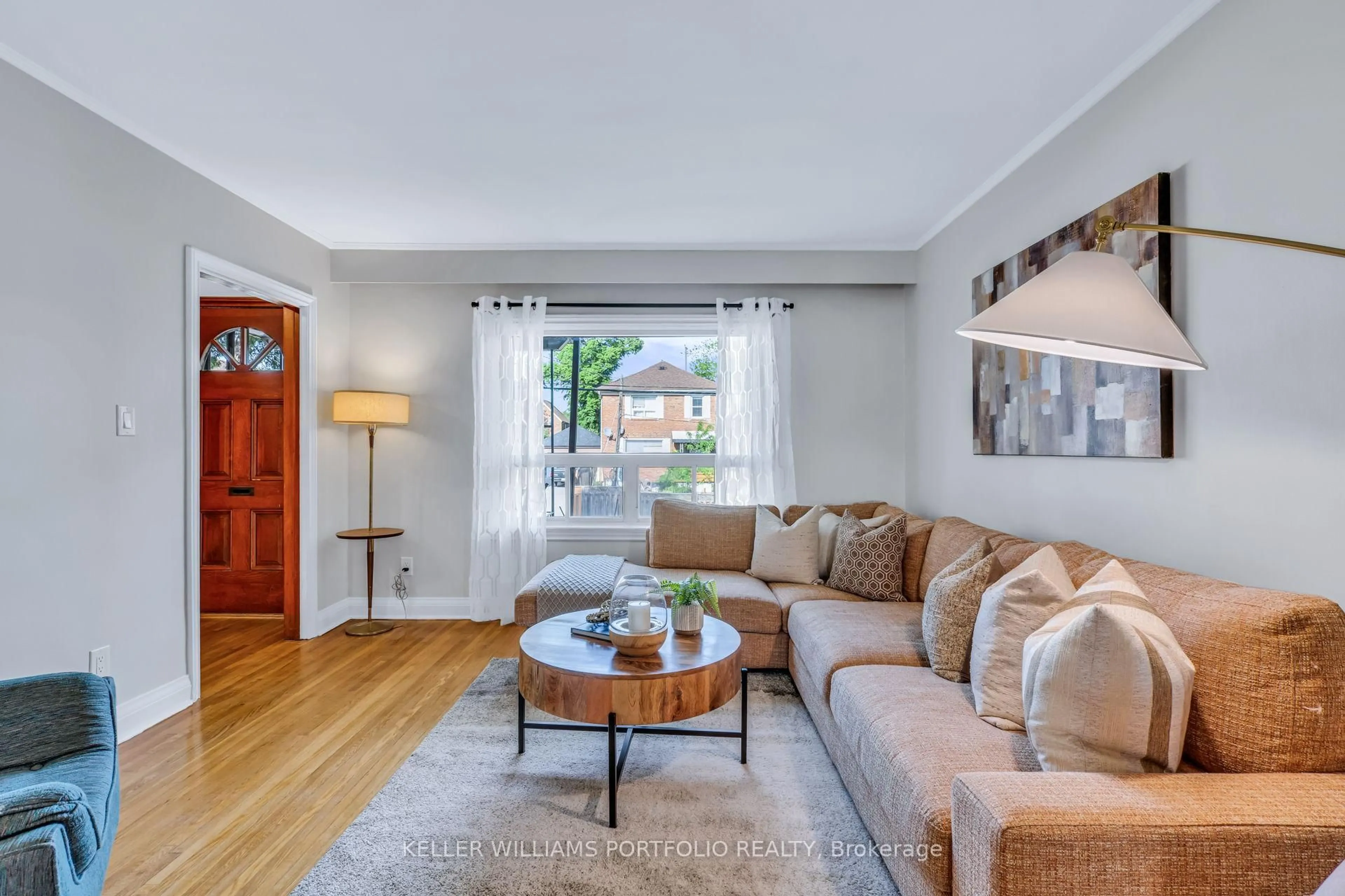 Living room with furniture, wood/laminate floor for 210 Bicknell Ave, Toronto Ontario M6M 4G9