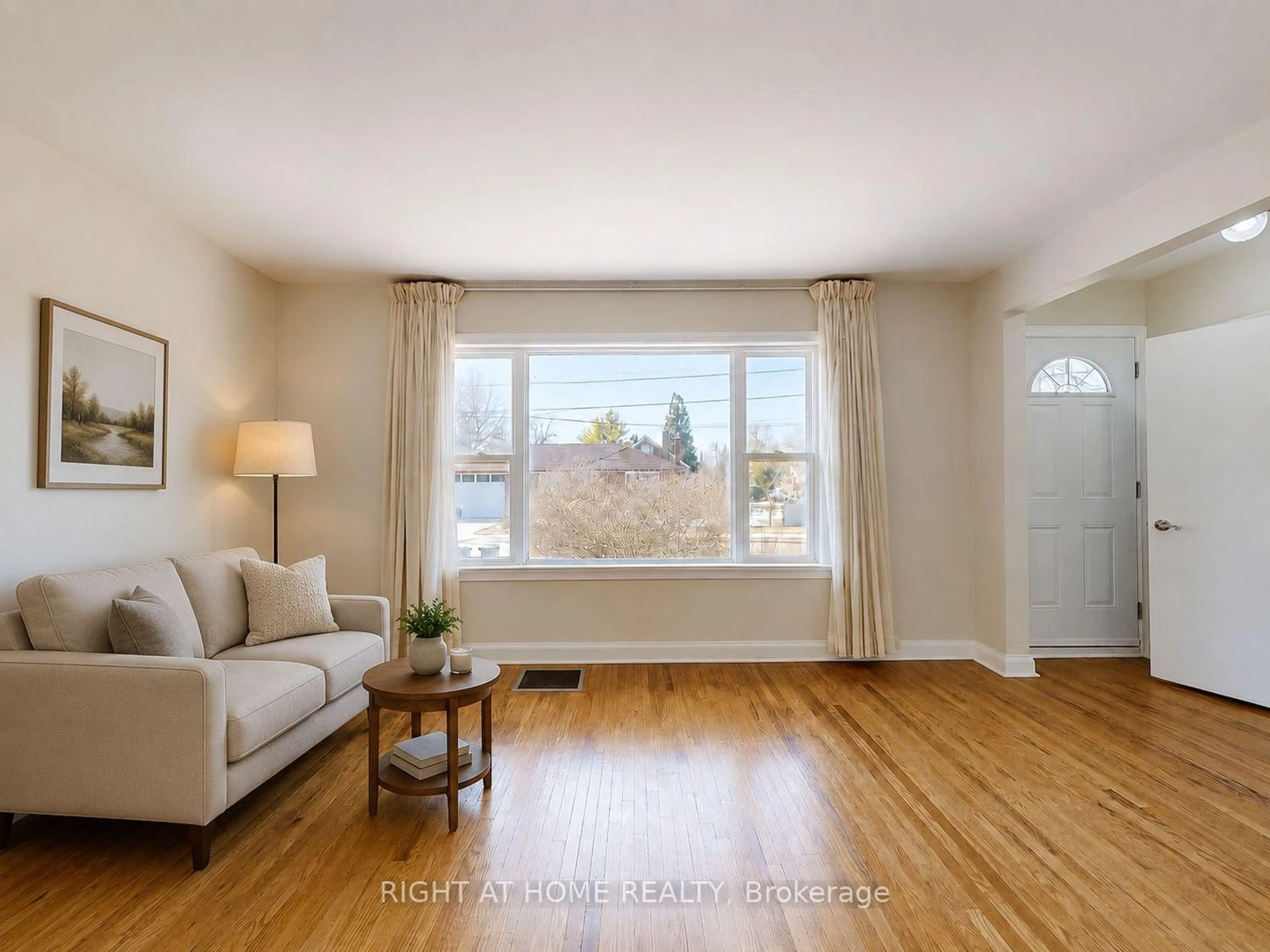 Living room with furniture, wood/laminate floor for 48 Loney Ave, Toronto Ontario M3L 1E9