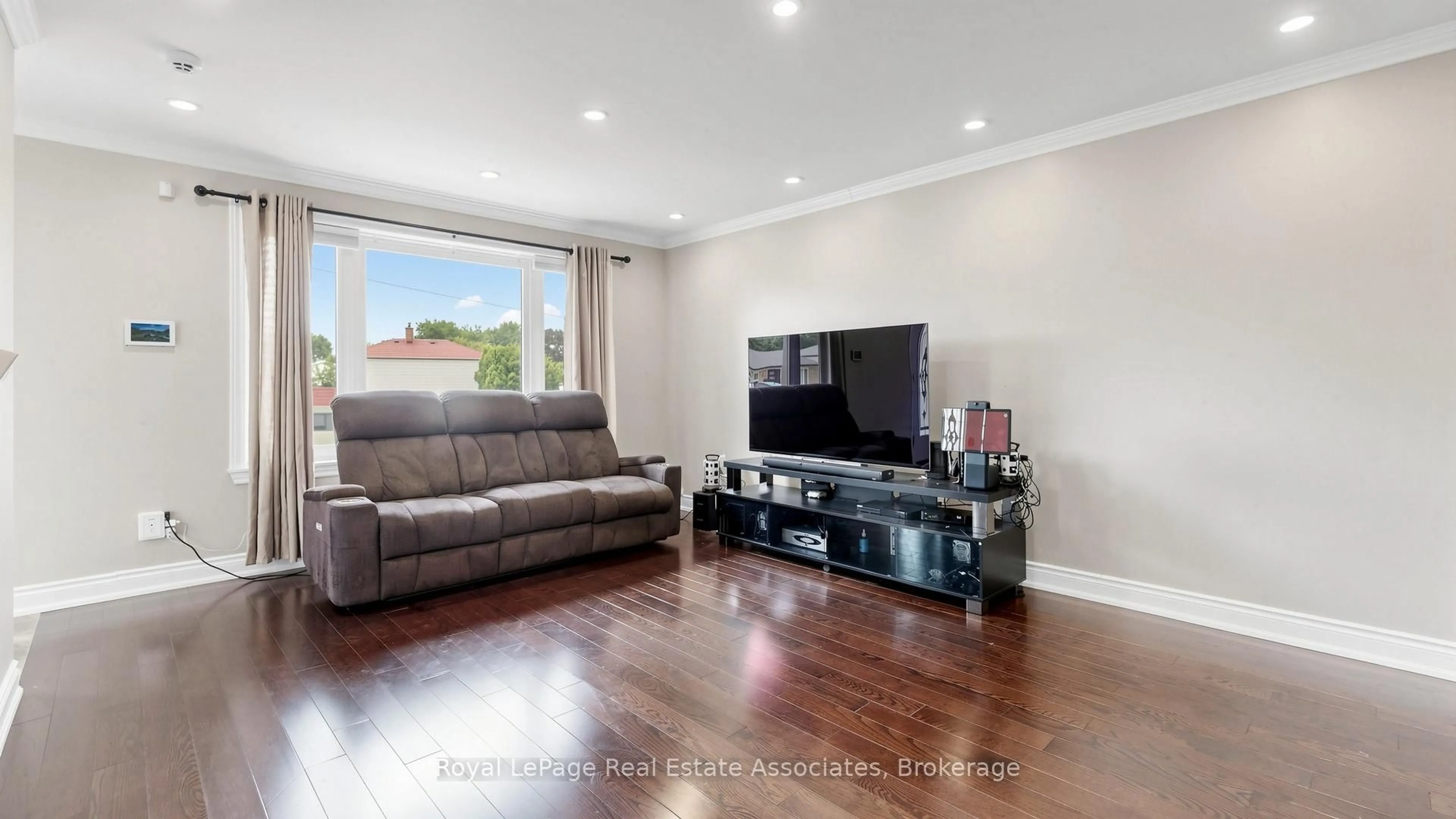 Living room with furniture, wood/laminate floor for 71 Addington Cres, Brampton Ontario L6T 2R4