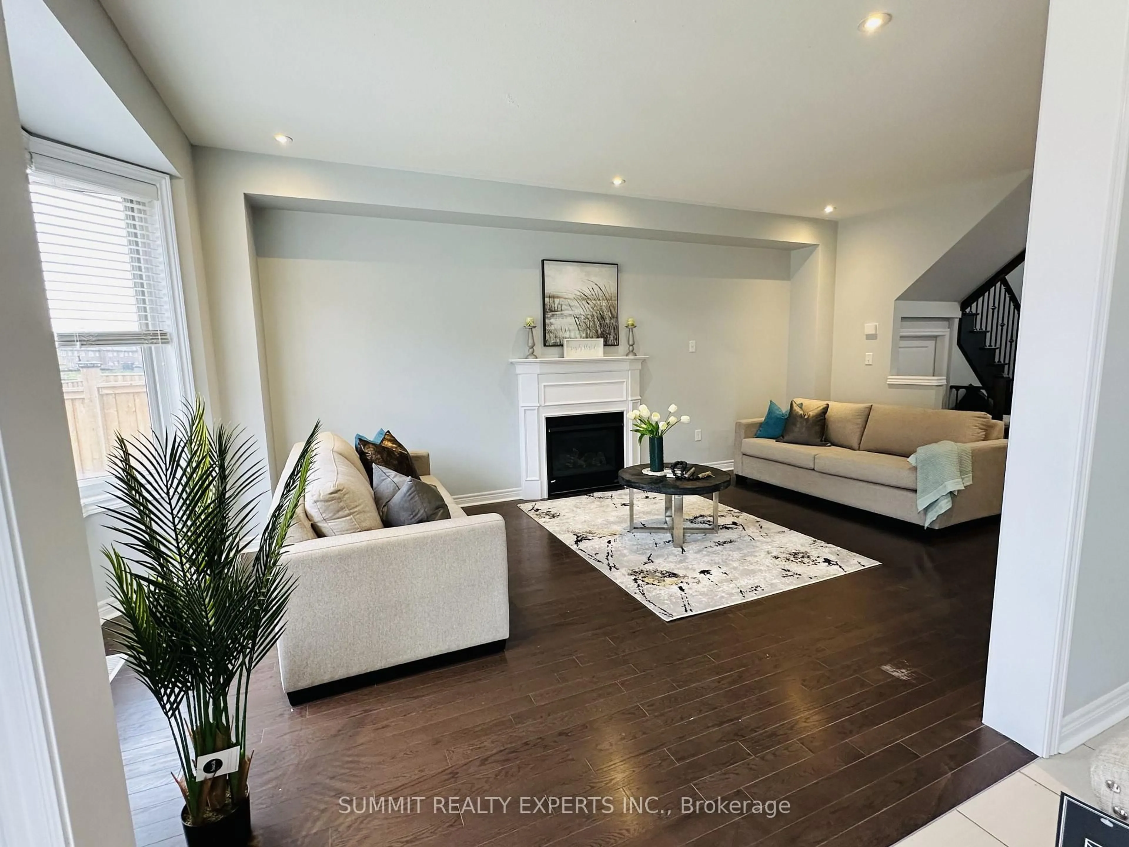 Living room with furniture, wood/laminate floor for 5 Merrybrook Tr, Brampton Ontario L7A 4W2
