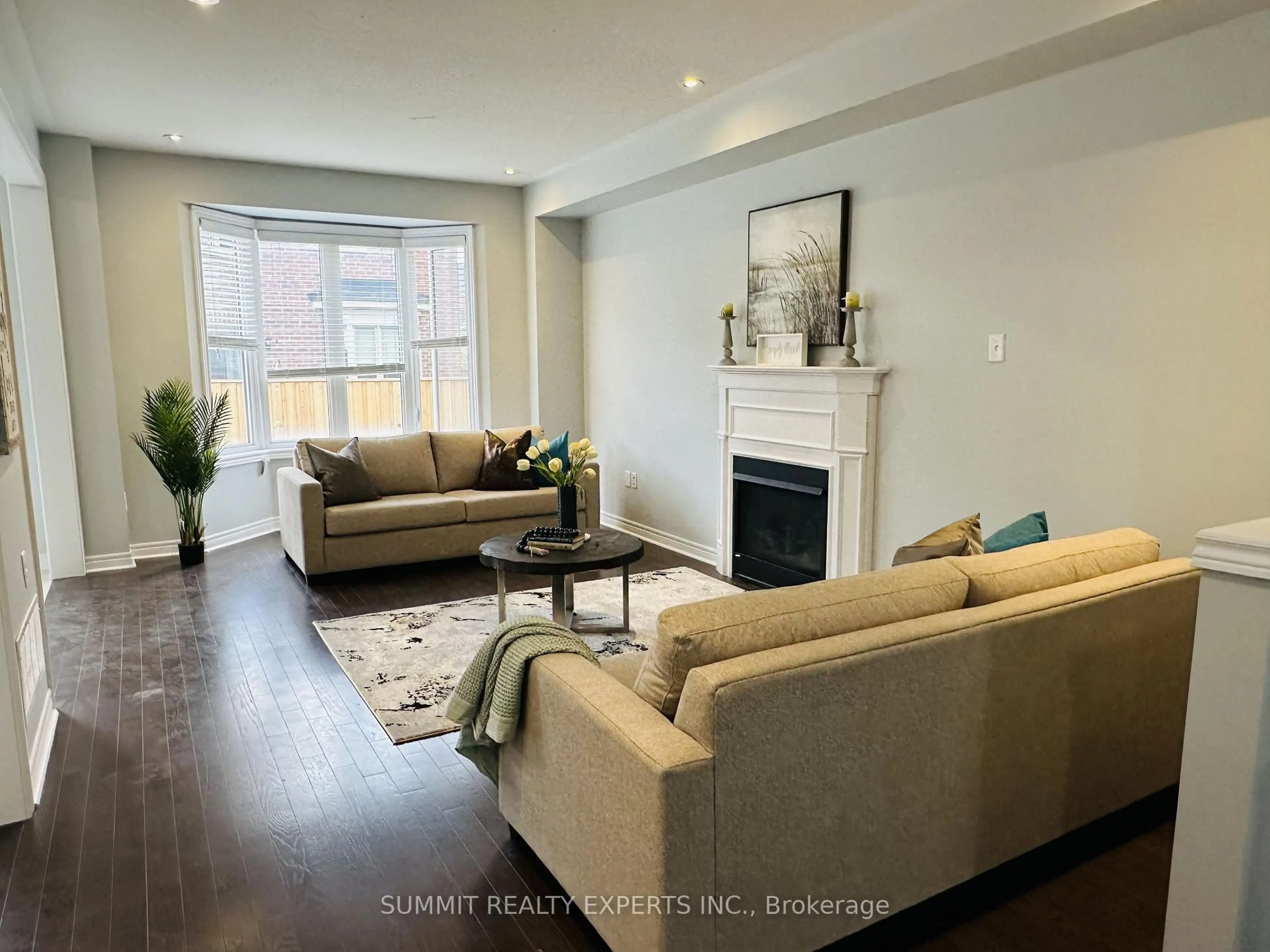 Living room with furniture, wood/laminate floor for 5 Merrybrook Tr, Brampton Ontario L7A 4W2