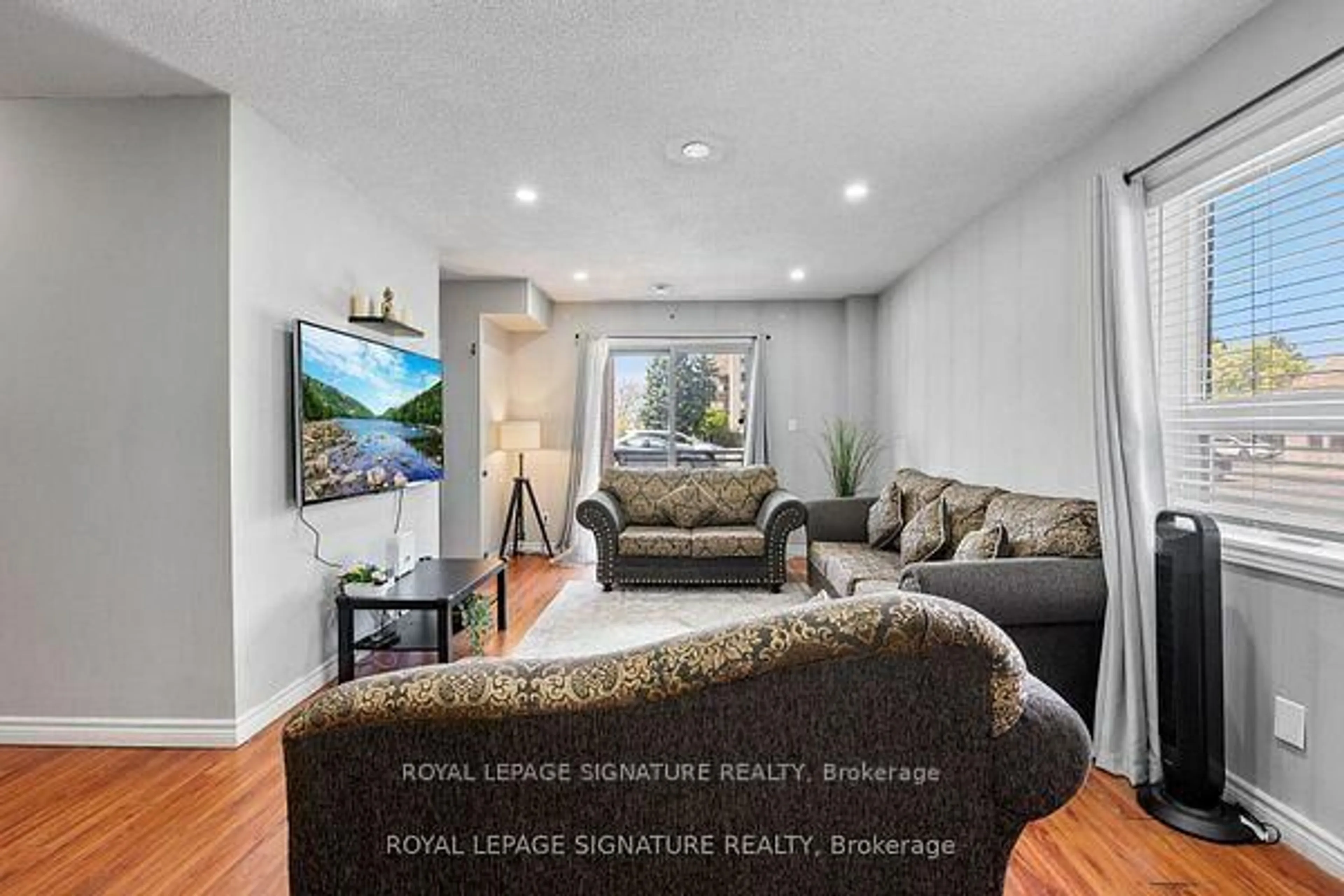 Living room with furniture, wood/laminate floor for 7405 Goreway Dr #104, Mississauga Ontario L4T 0A3