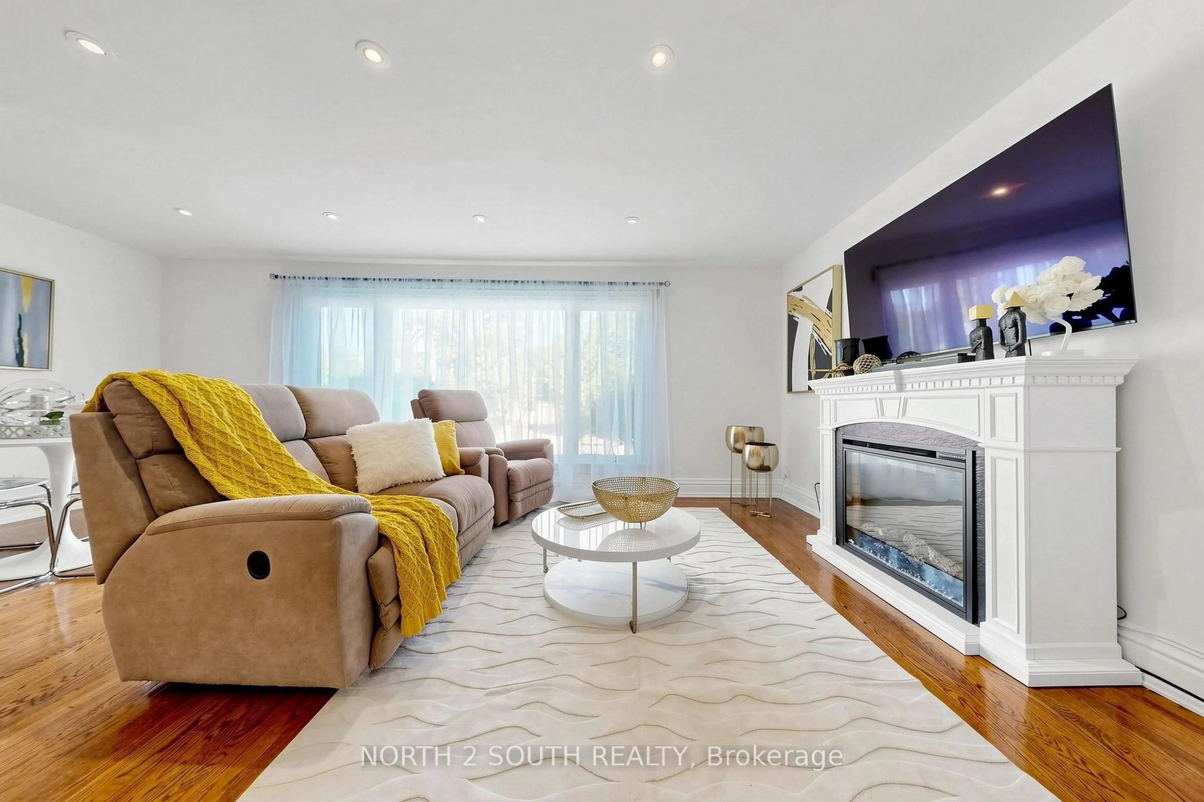 Living room with furniture, wood/laminate floor for 263 Thistle Down Blvd, Toronto Ontario M9V 1K6