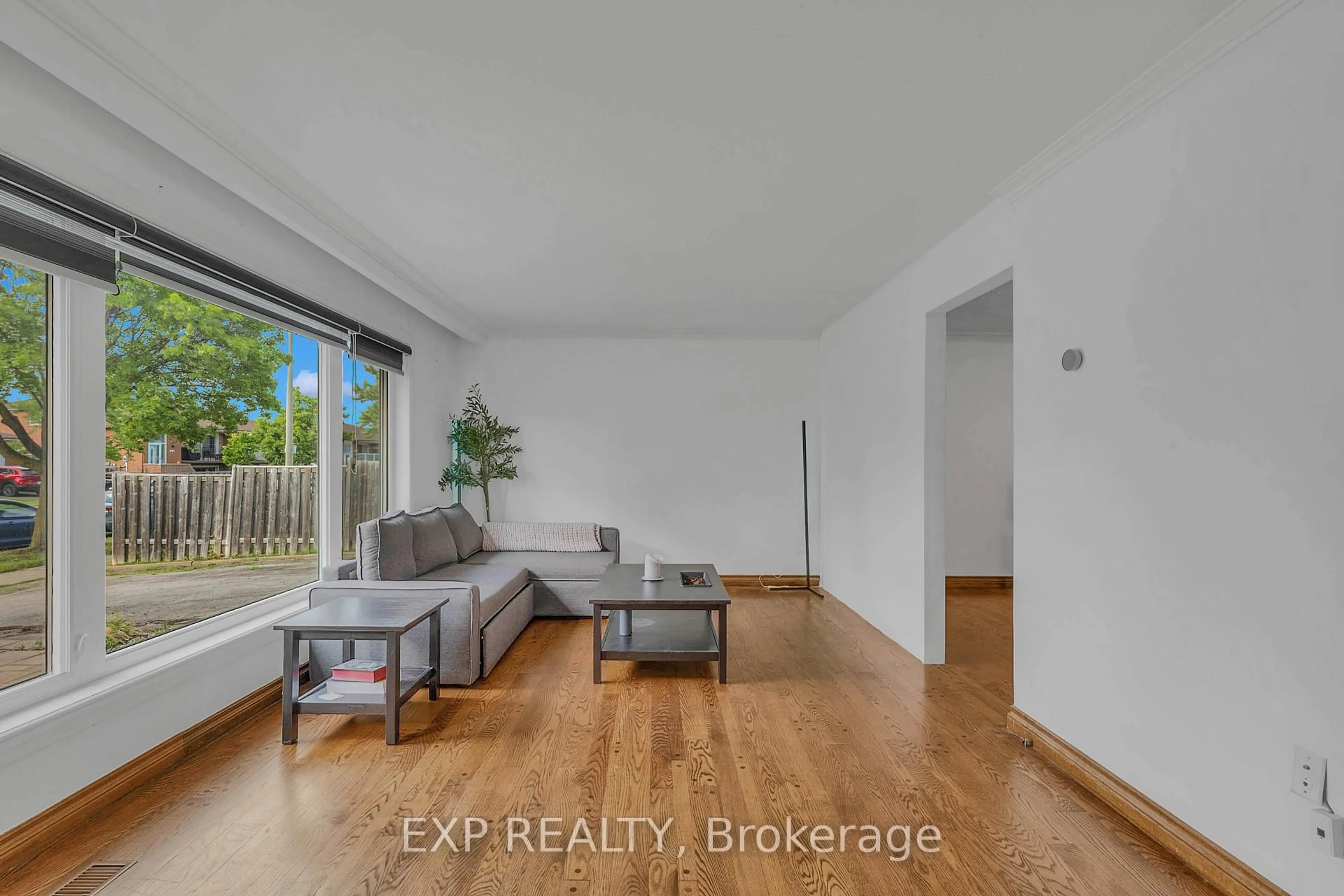 Living room with furniture, wood/laminate floor for 7201 Sigsbee Dr, Mississauga Ontario L4T 3L6