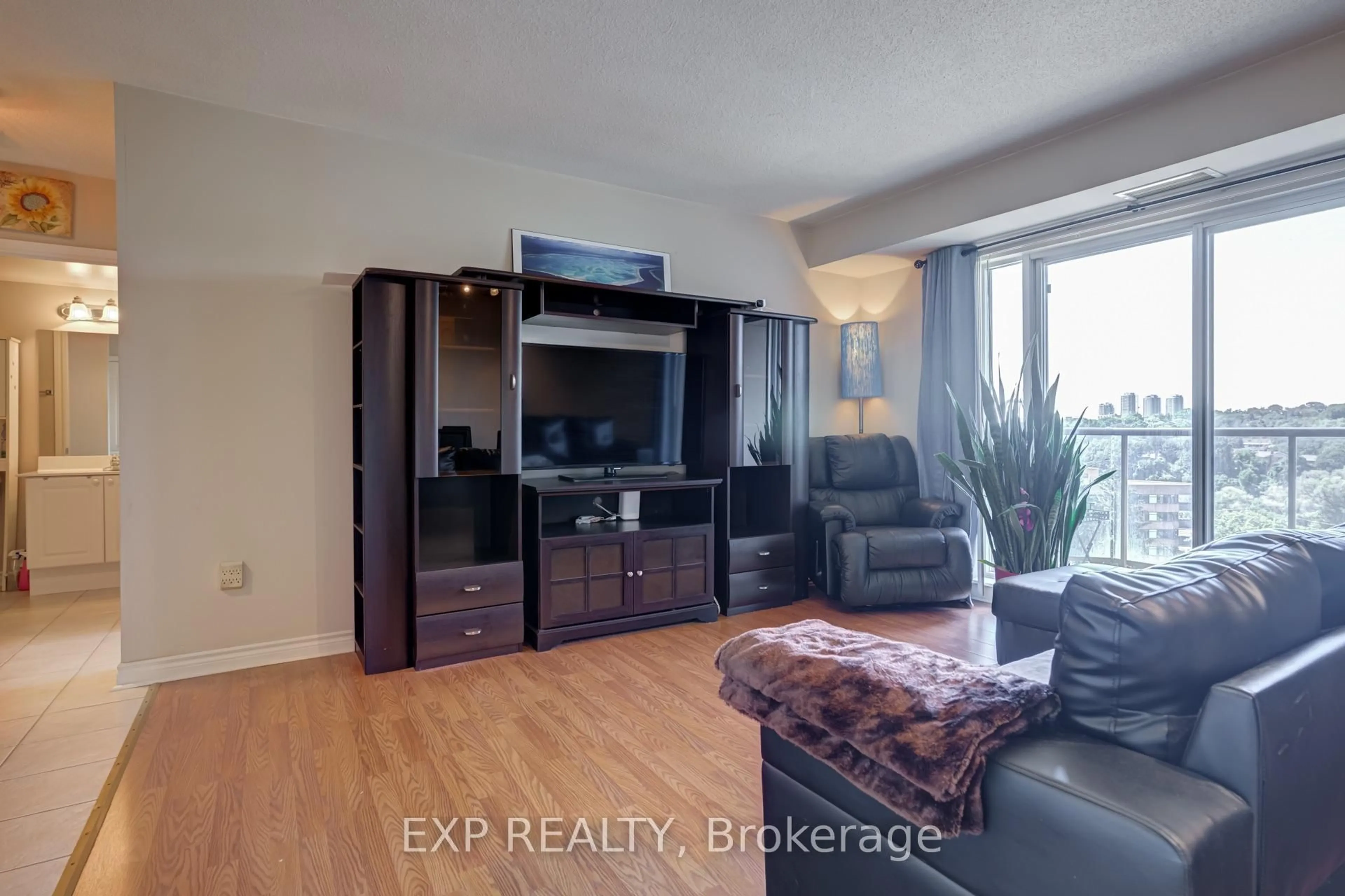 Living room with furniture, wood/laminate floor for 2088 Lawrence Ave #707, Toronto Ontario M9N 3Z9