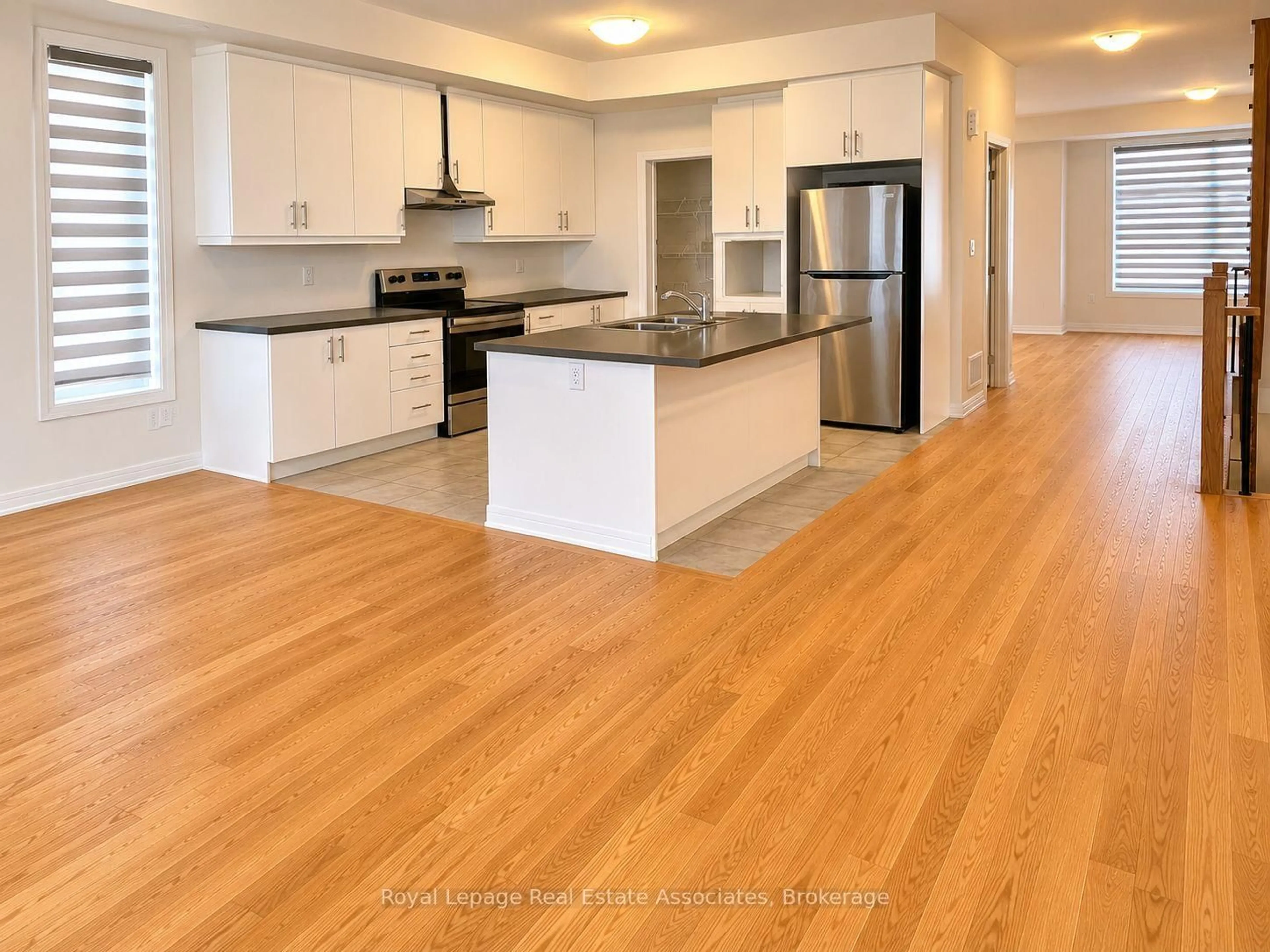 Open concept kitchen, wood/laminate floor for 16 Bonnington Dr, Brampton Ontario L7A 5M1