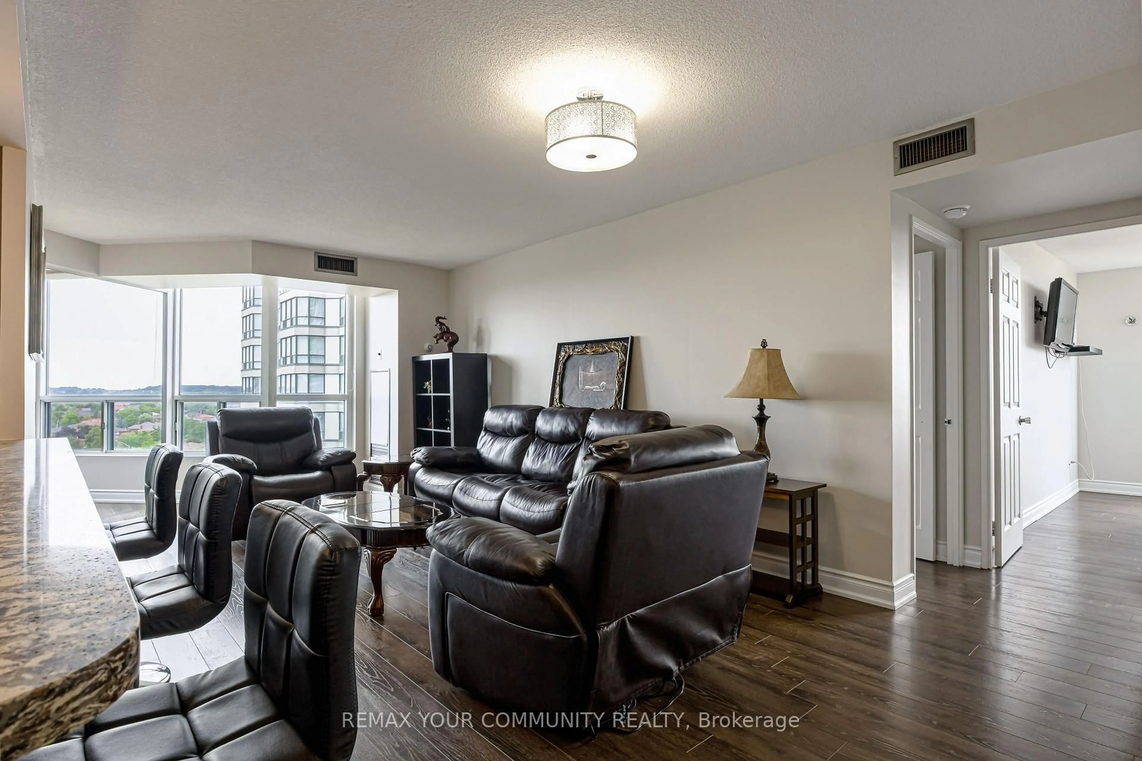 Living room with furniture, wood/laminate floor for 4460 Tucana Crt #910, Mississauga Ontario L5R 3K9