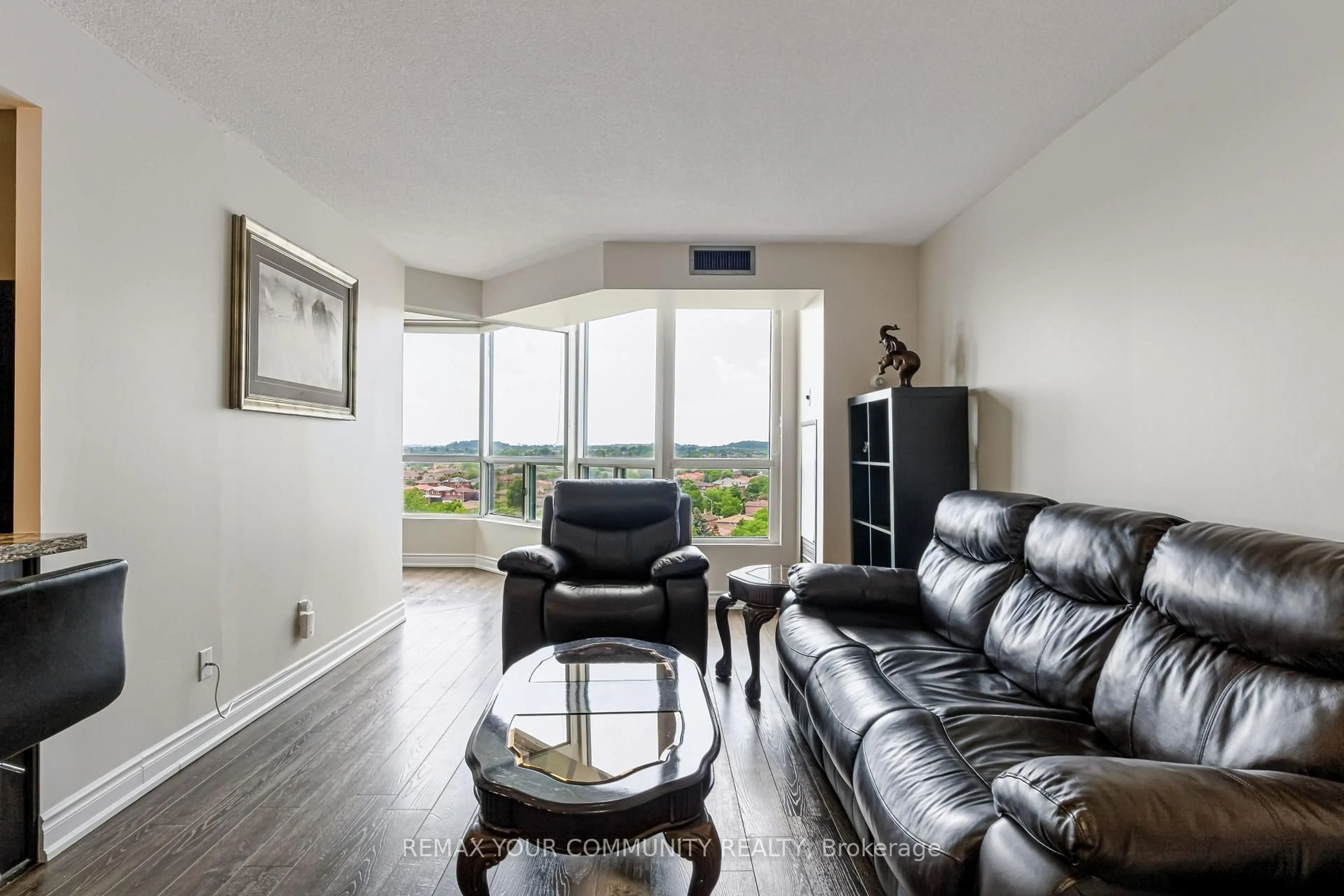 Living room with furniture, wood/laminate floor for 4460 Tucana Crt #910, Mississauga Ontario L5R 3K9