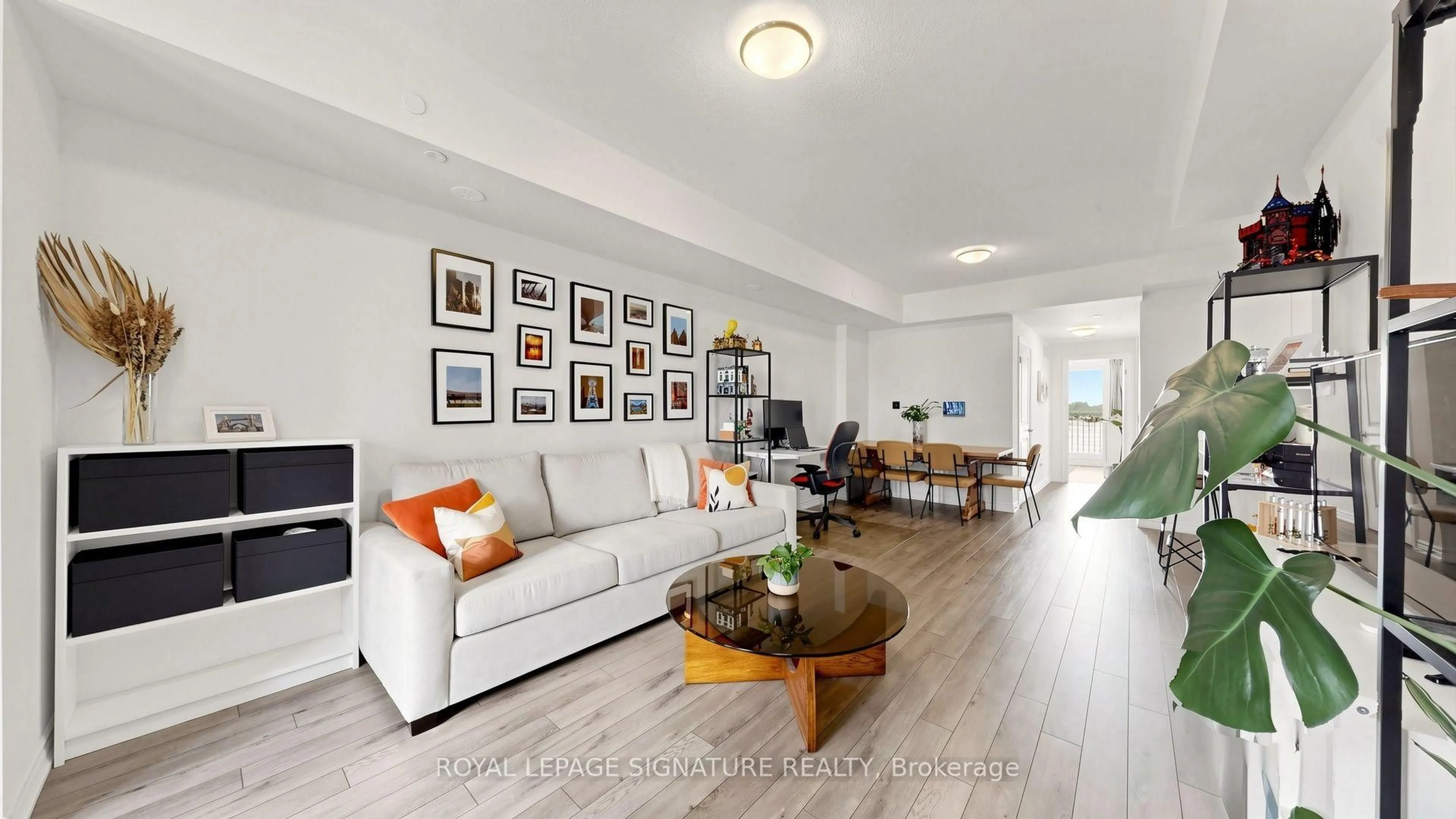 Living room with furniture, wood/laminate floor for 349 Wheat Boom Dr #222, Oakville Ontario L6H 7X5