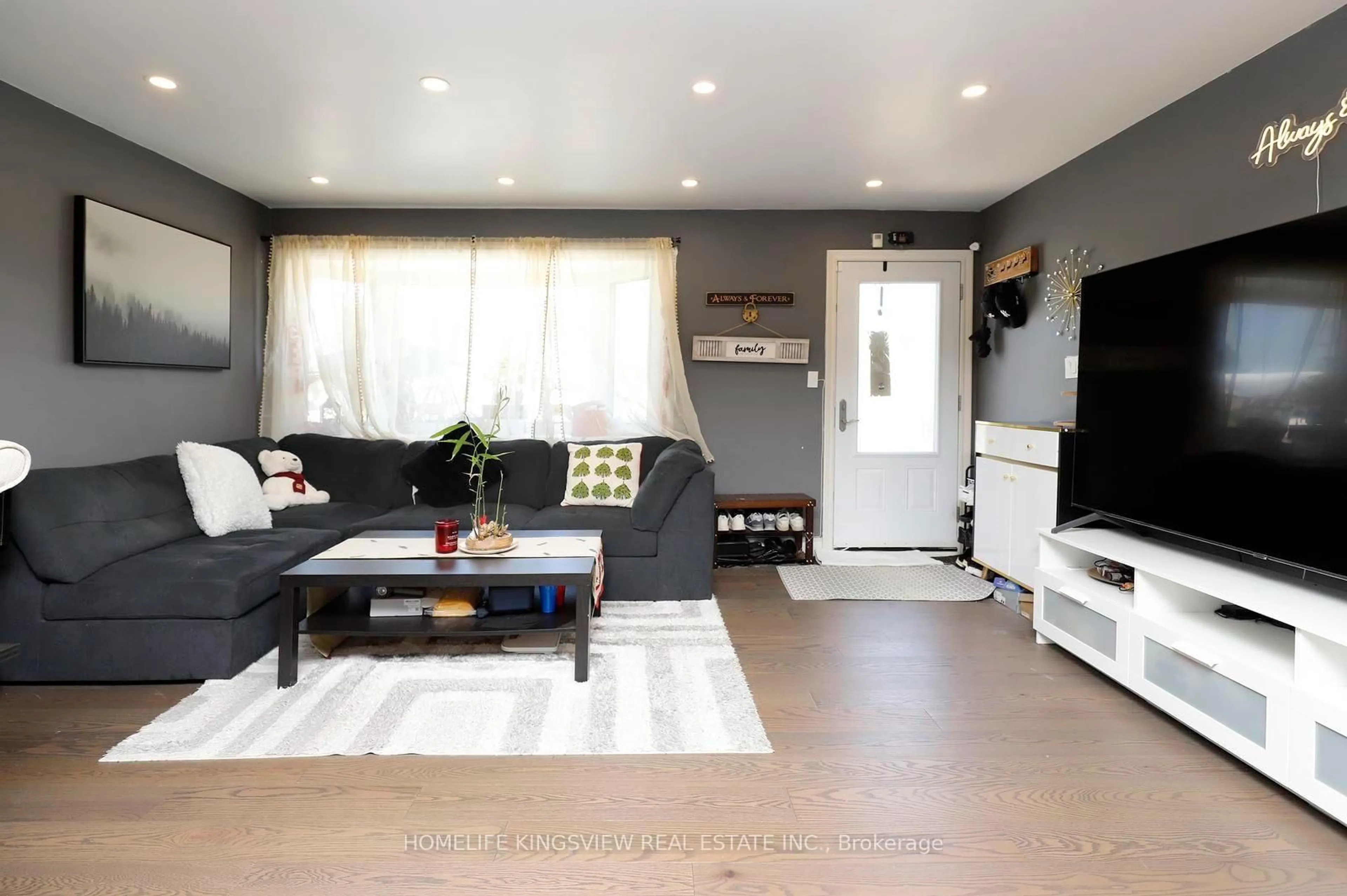 Living room with furniture, wood/laminate floor for 110 Longfield Rd, Halton Hills Ontario L7J 2K4
