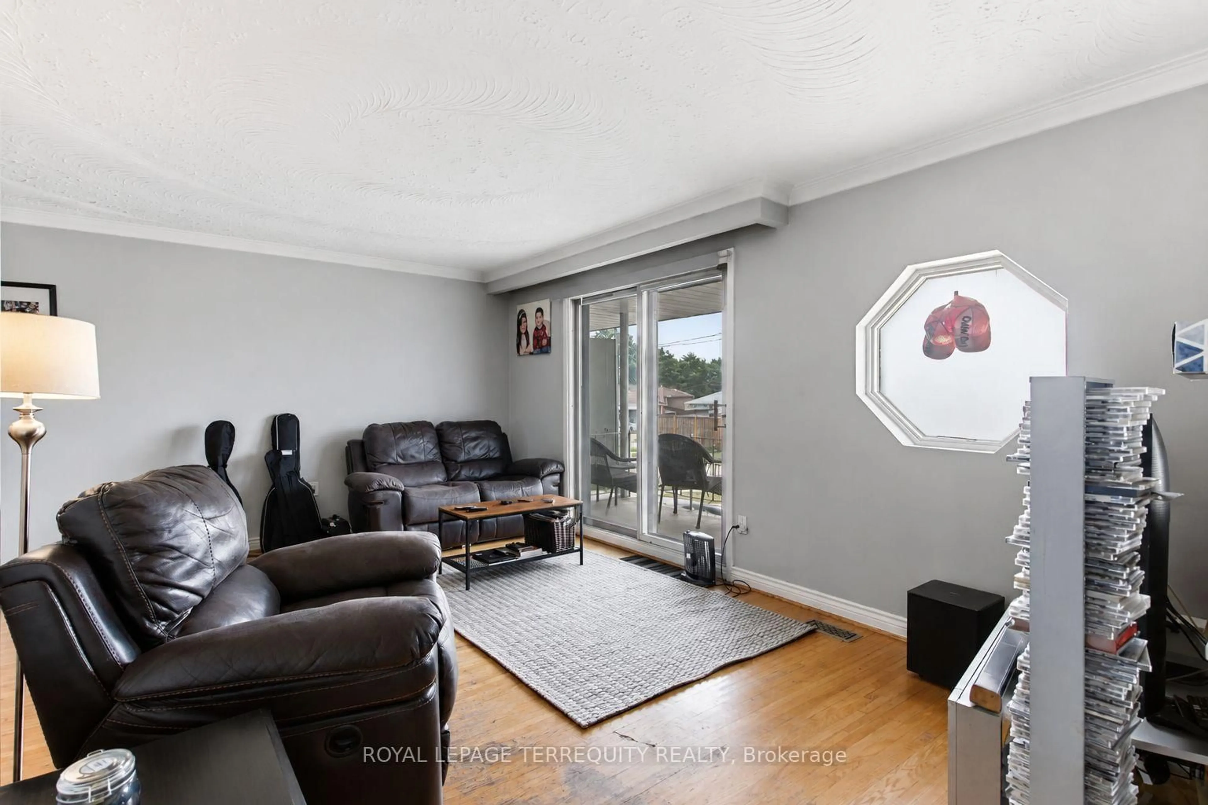 Living room with furniture, wood/laminate floor for 21 Buckland Rd, Toronto Ontario M3L 1V9