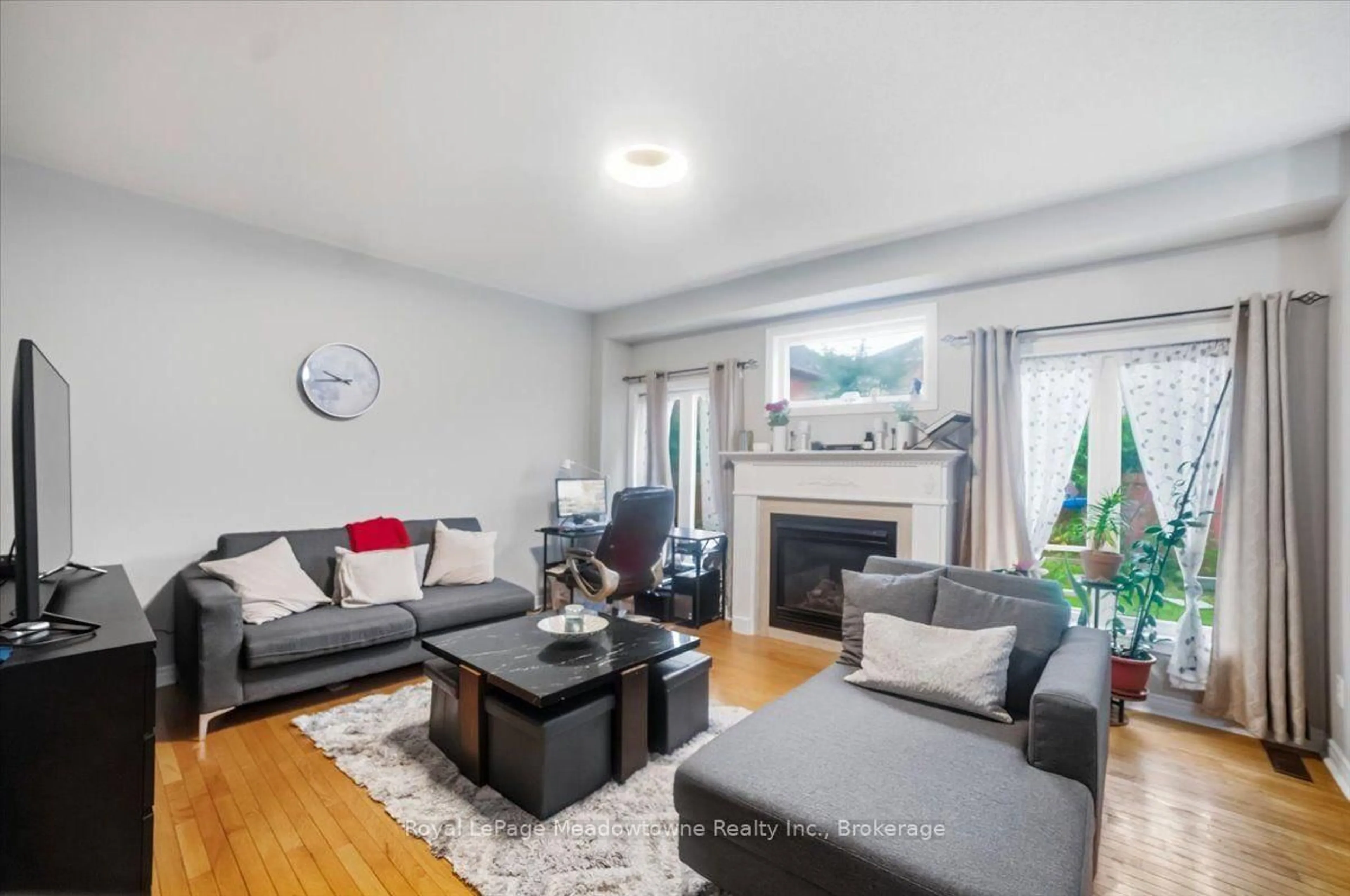 Living room with furniture, wood/laminate floor for 68 Game Creek Cres, Brampton Ontario L7A 0K3