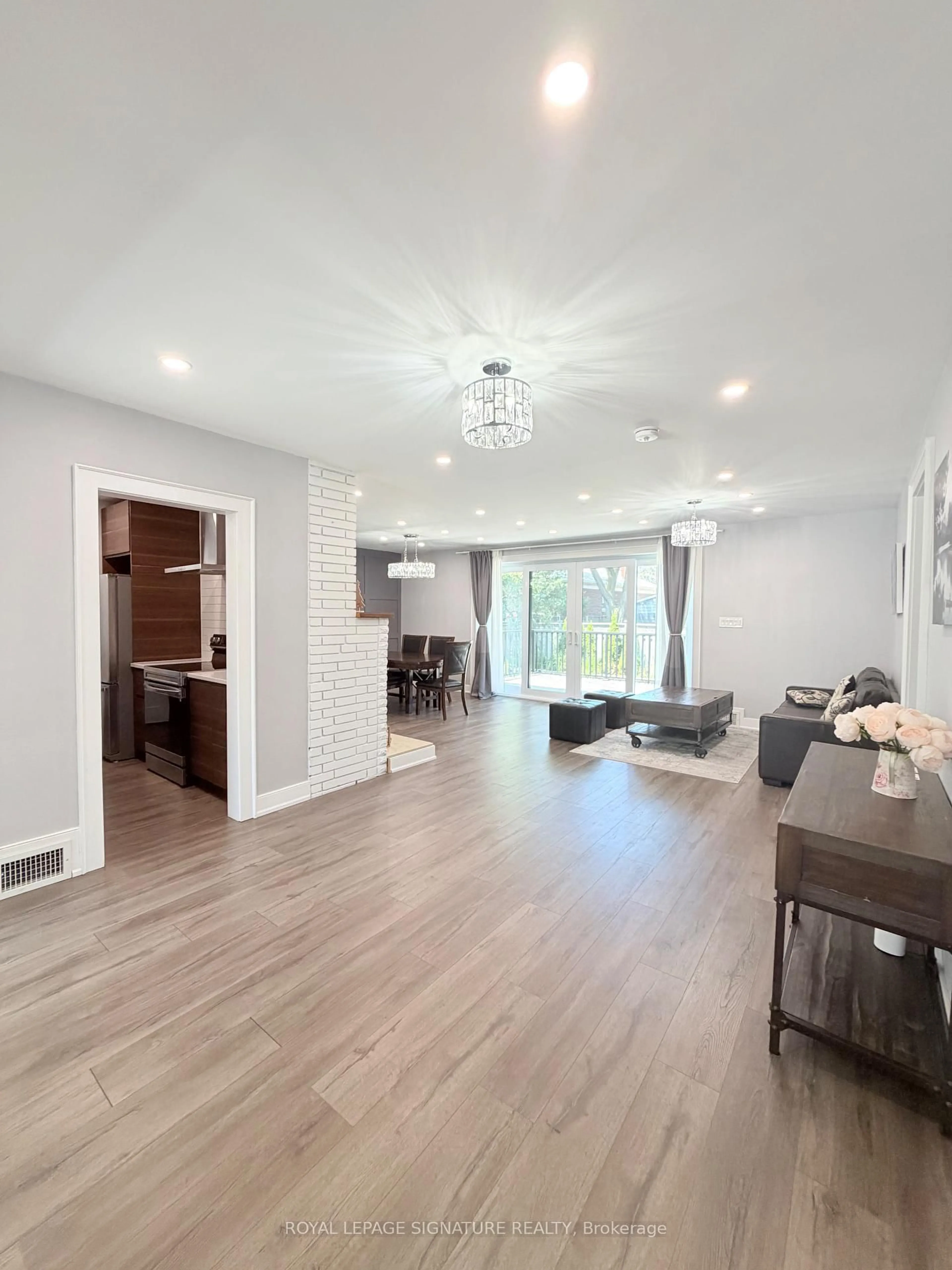 Living room with furniture, wood/laminate floor for 104 Great Oak Dr, Toronto Ontario M9A 1N5