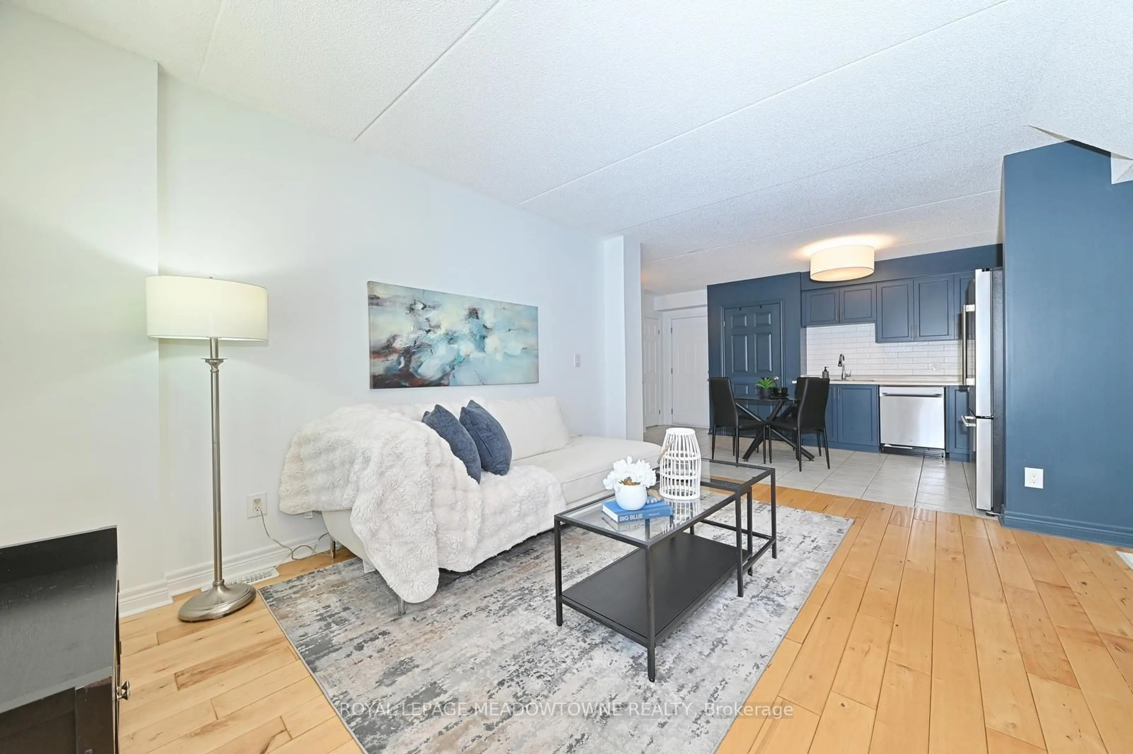 Living room with furniture, wood/laminate floor for 1380 Costigan Rd #59, Milton Ontario L9T 8L2
