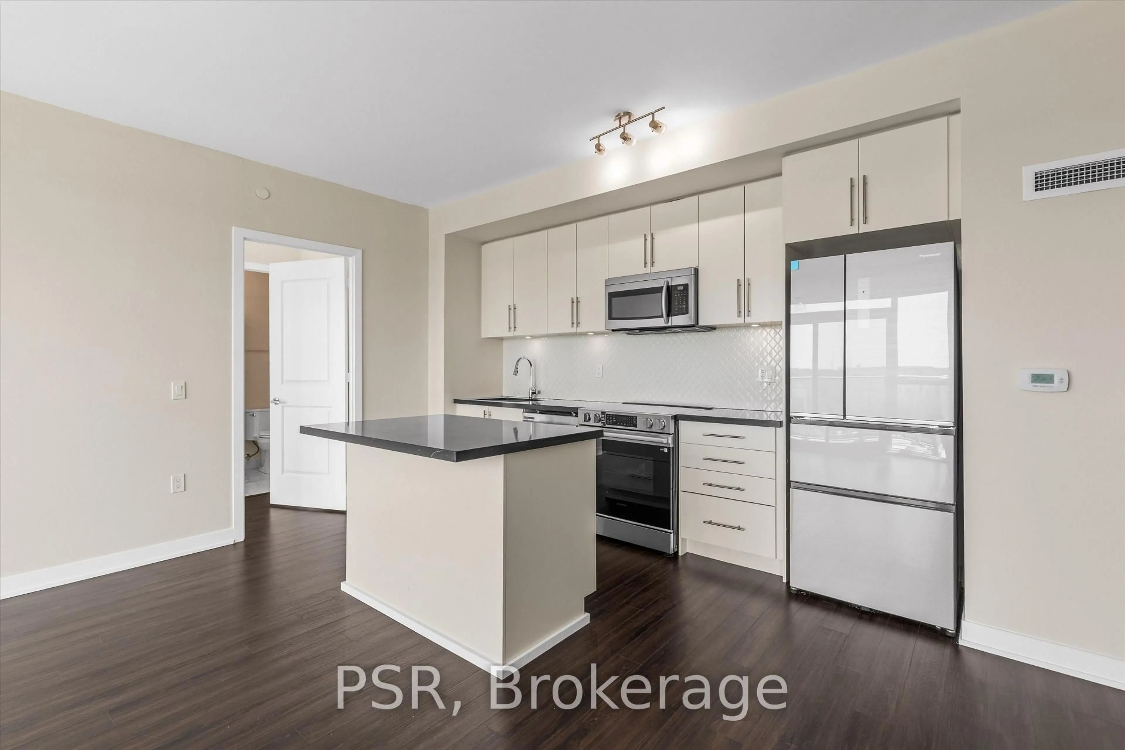 Open concept kitchen, wood/laminate floor for 4699 Glen Erin Dr #407, Mississauga Ontario L5M 2E5