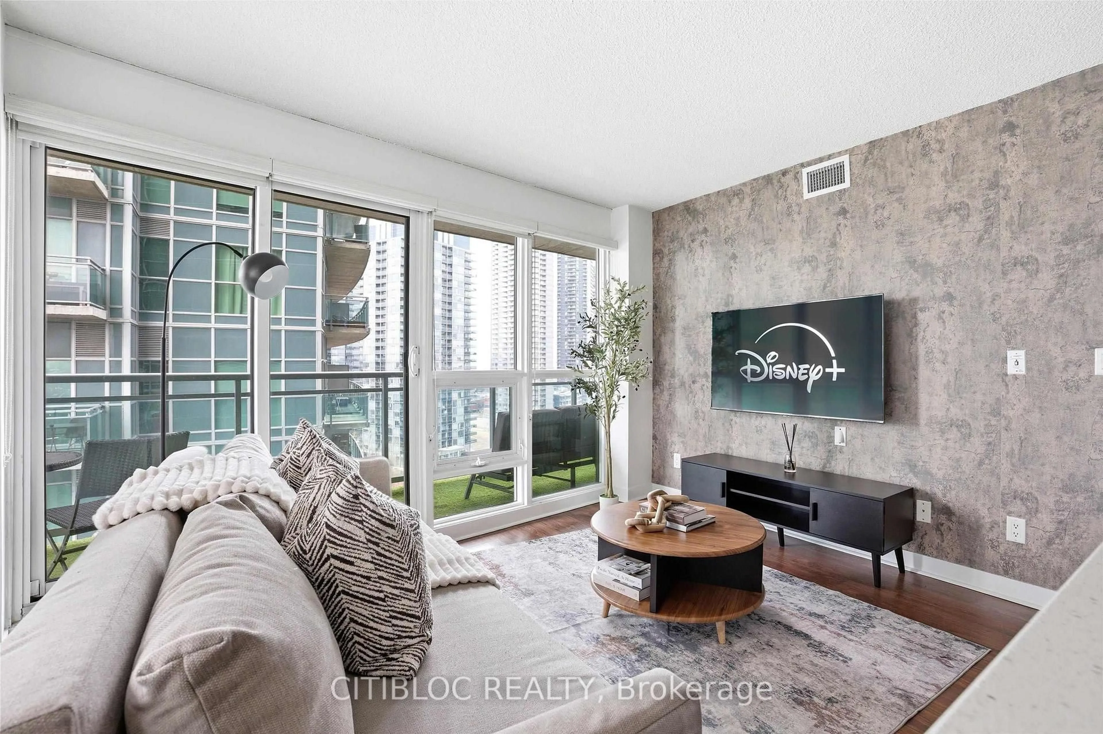 Living room with furniture, cement floor for 155 Legion Rd #1313, Toronto Ontario M8Y 0A7