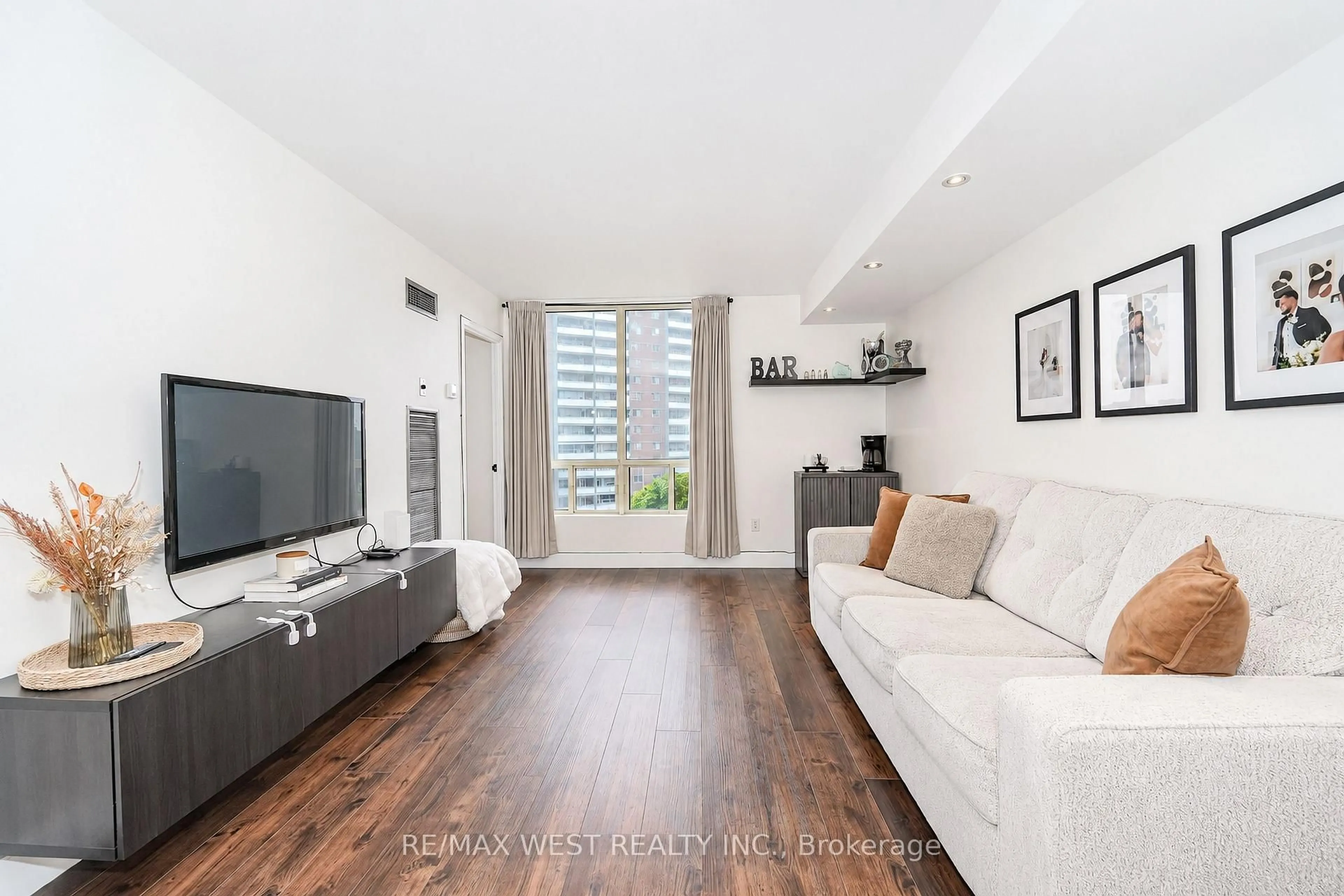 Living room with furniture, wood/laminate floor for 3 Hickory Tree Rd #907, Toronto Ontario M9N 3W5