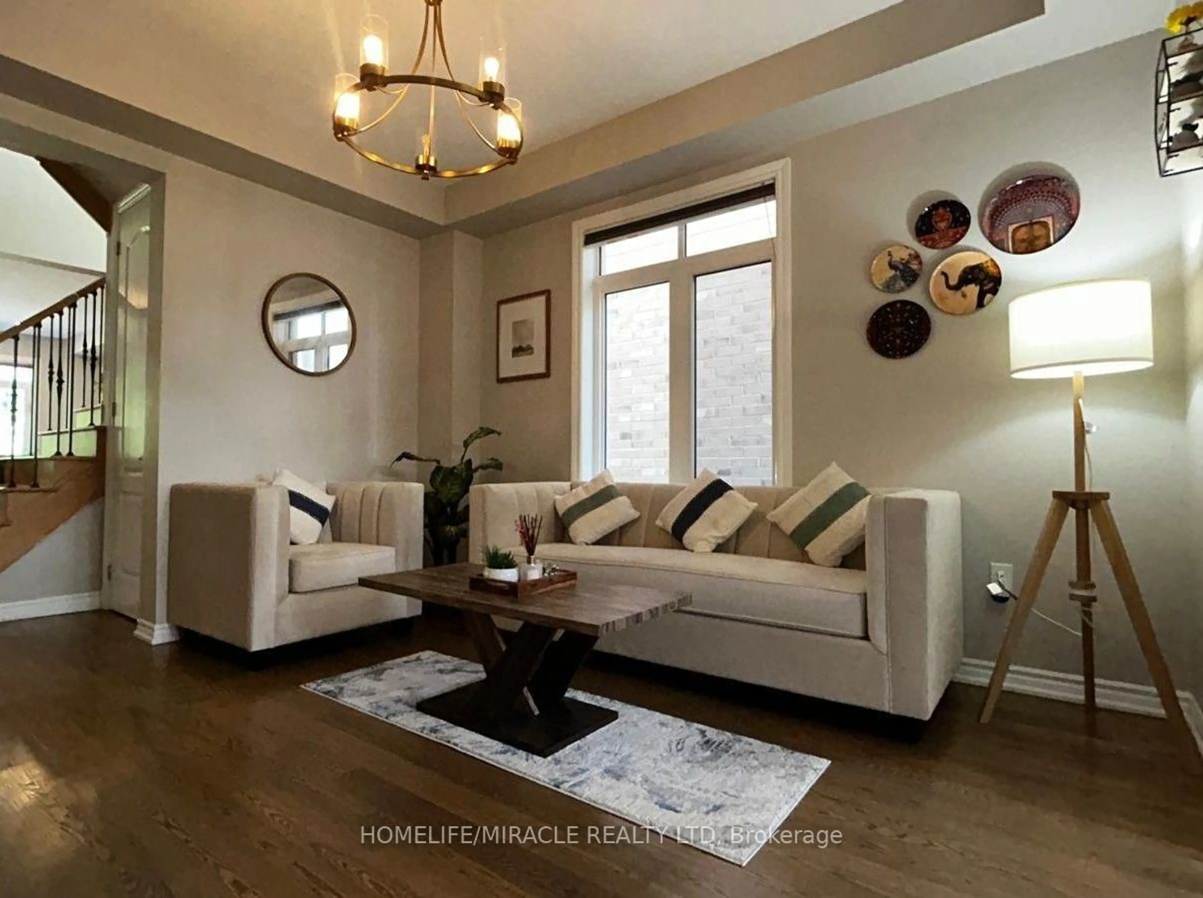 Living room with furniture, wood/laminate floor for 185 Thornbush Blvd, Brampton Ontario L7A 4R5